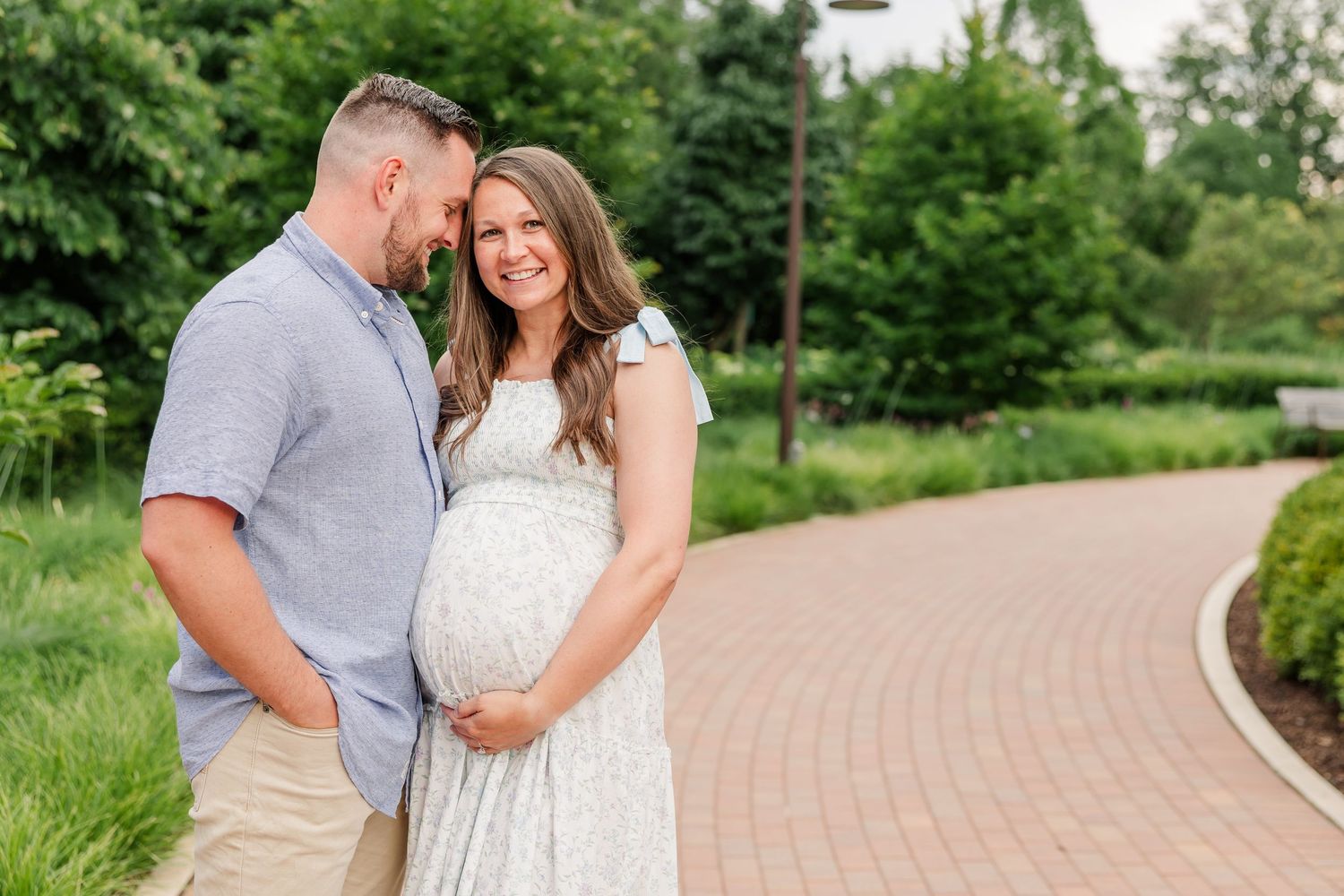Expecting parents snuggling during a romantic maternity session at Cantigny Park