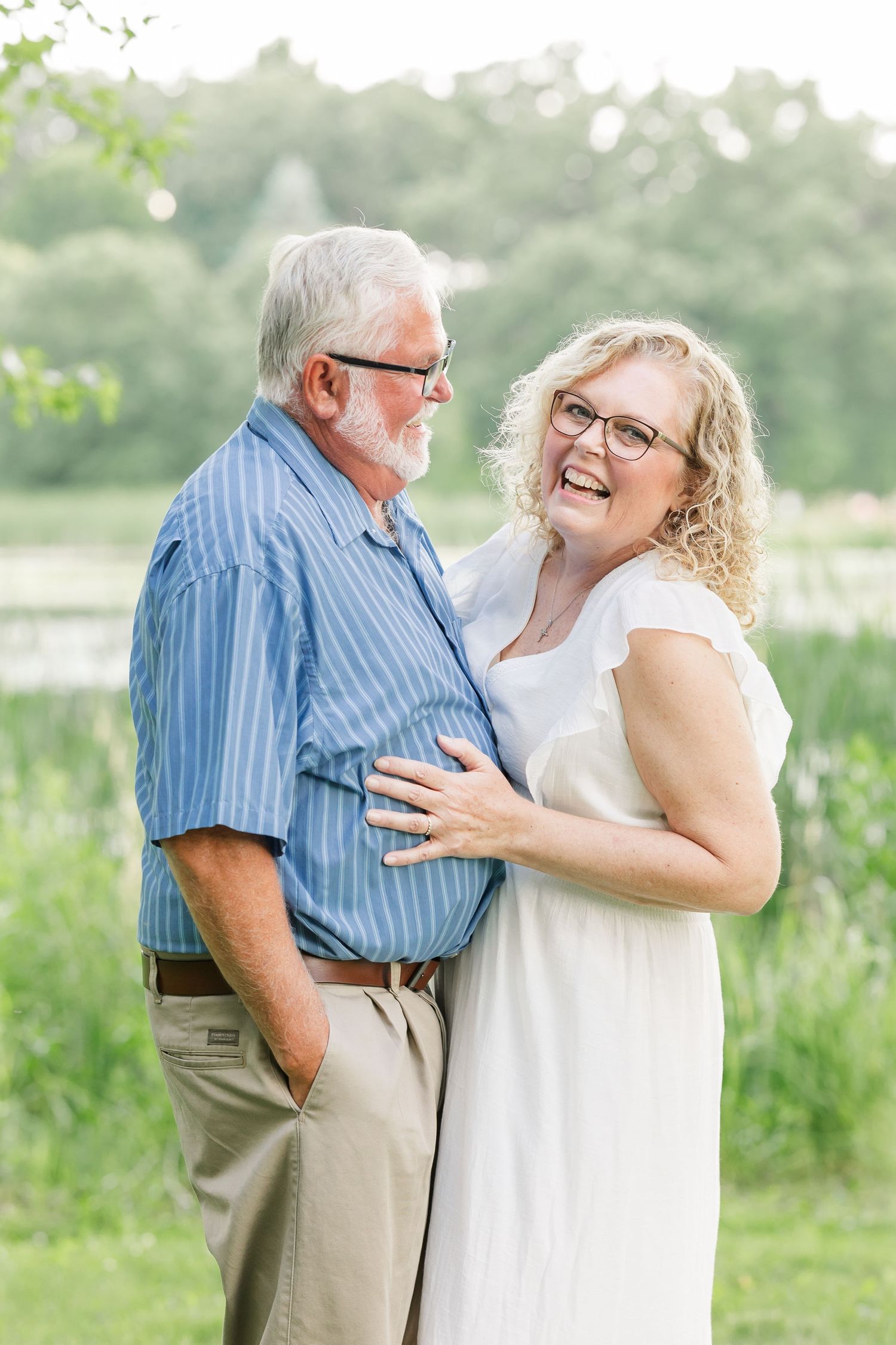 Grandparents laughing together during a sweet summer family portrait session in Crystal Lake, Illinois