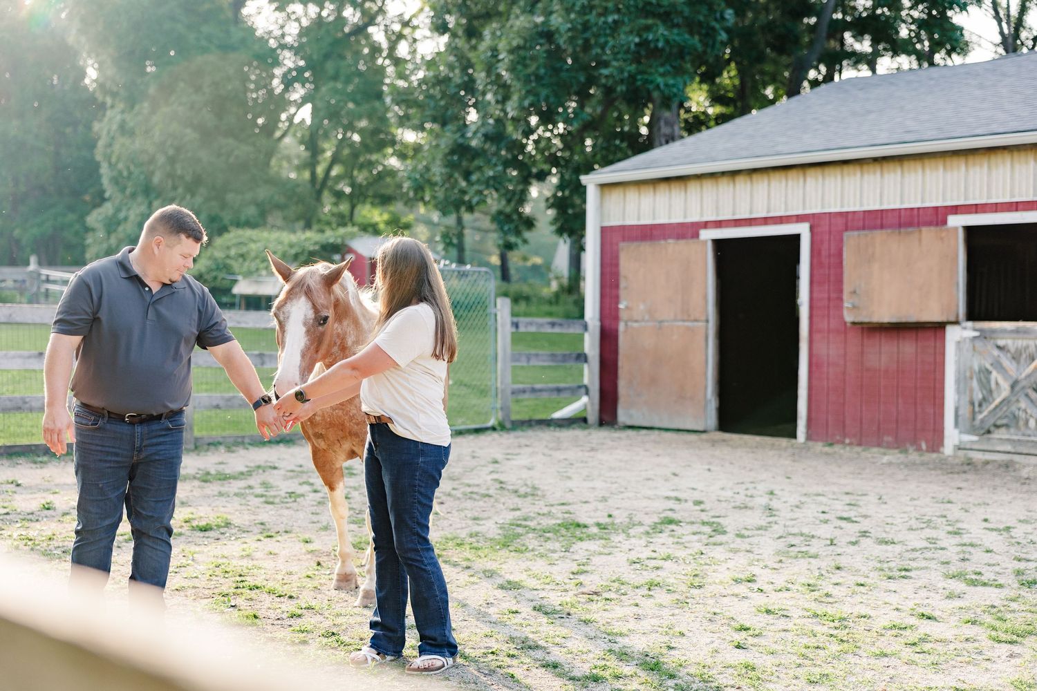 Parents feeding one of their horses at their Bull Valley, Illinois home.