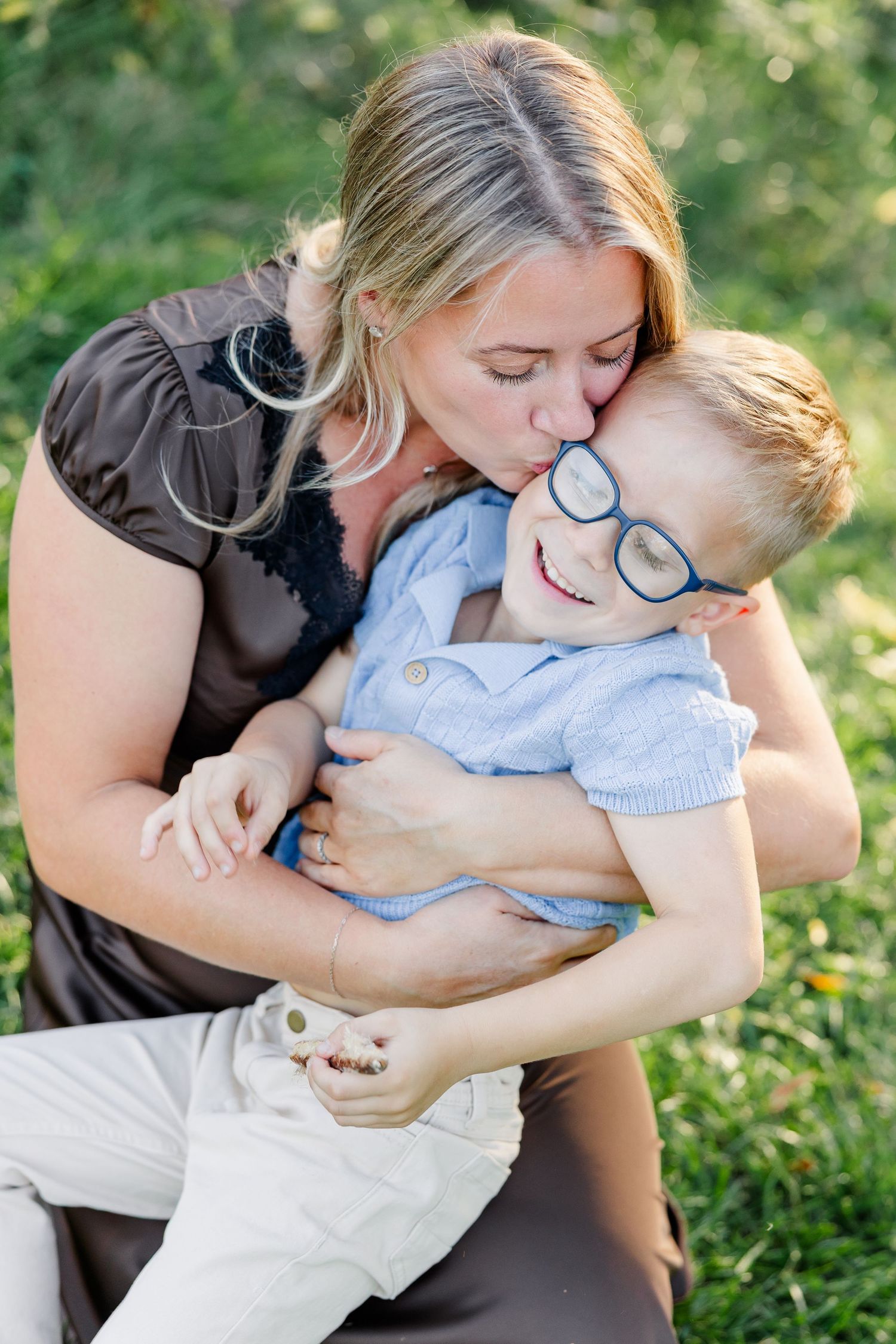 Mom kissing her son's cheek during fall family photos at home in St. Charles, IL.