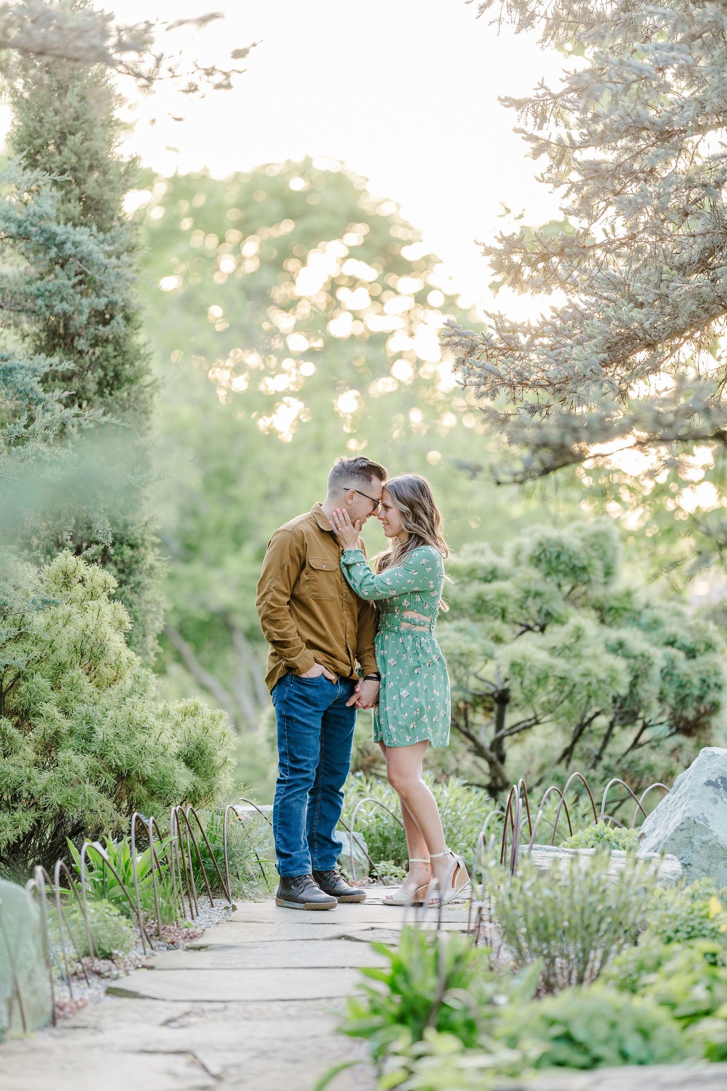 Engaged couple kissing in the gardens at Cantigny Park in Wheaton
