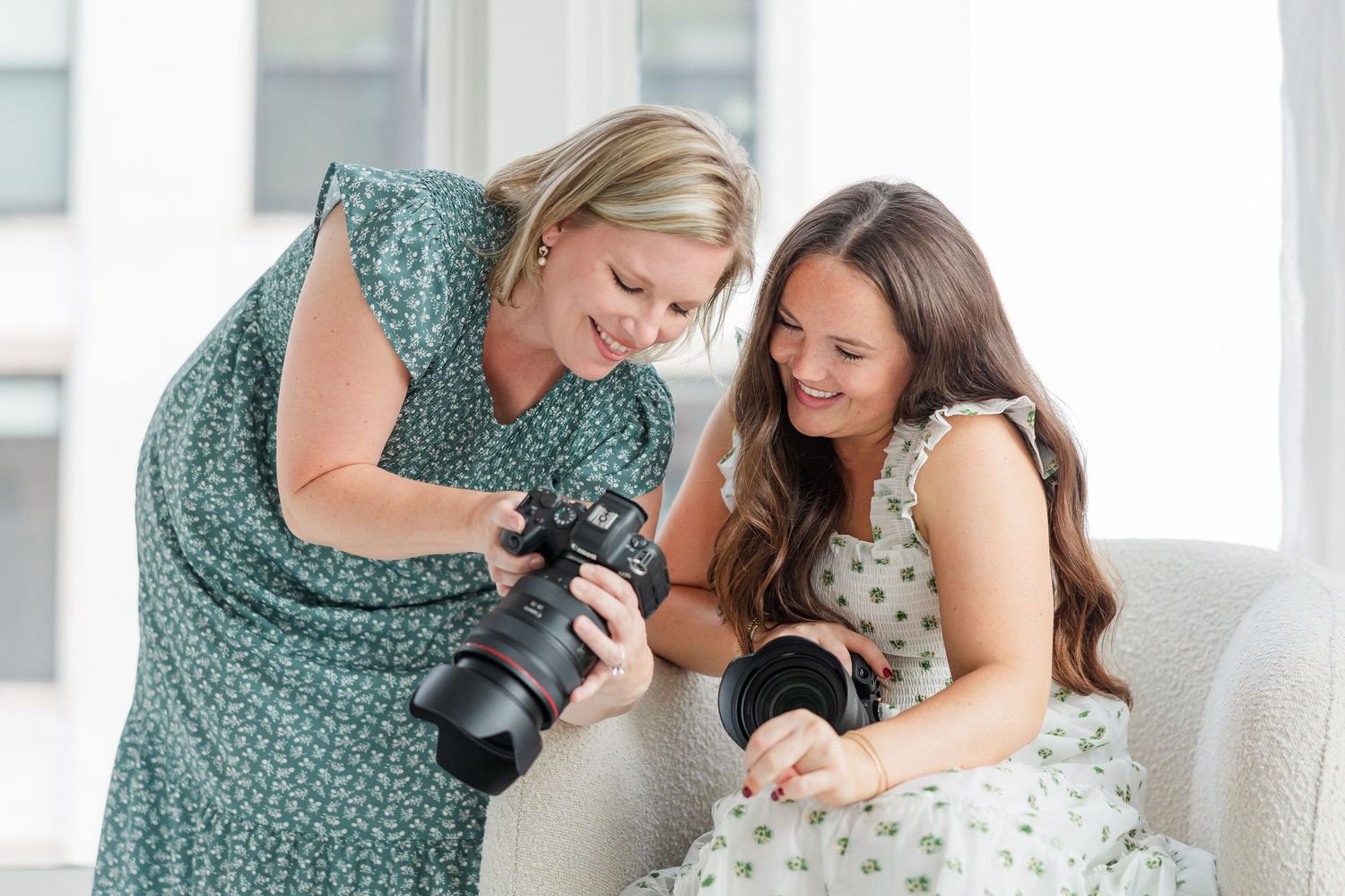 Cassie Lacina reviewing wedding images on camera with a bride