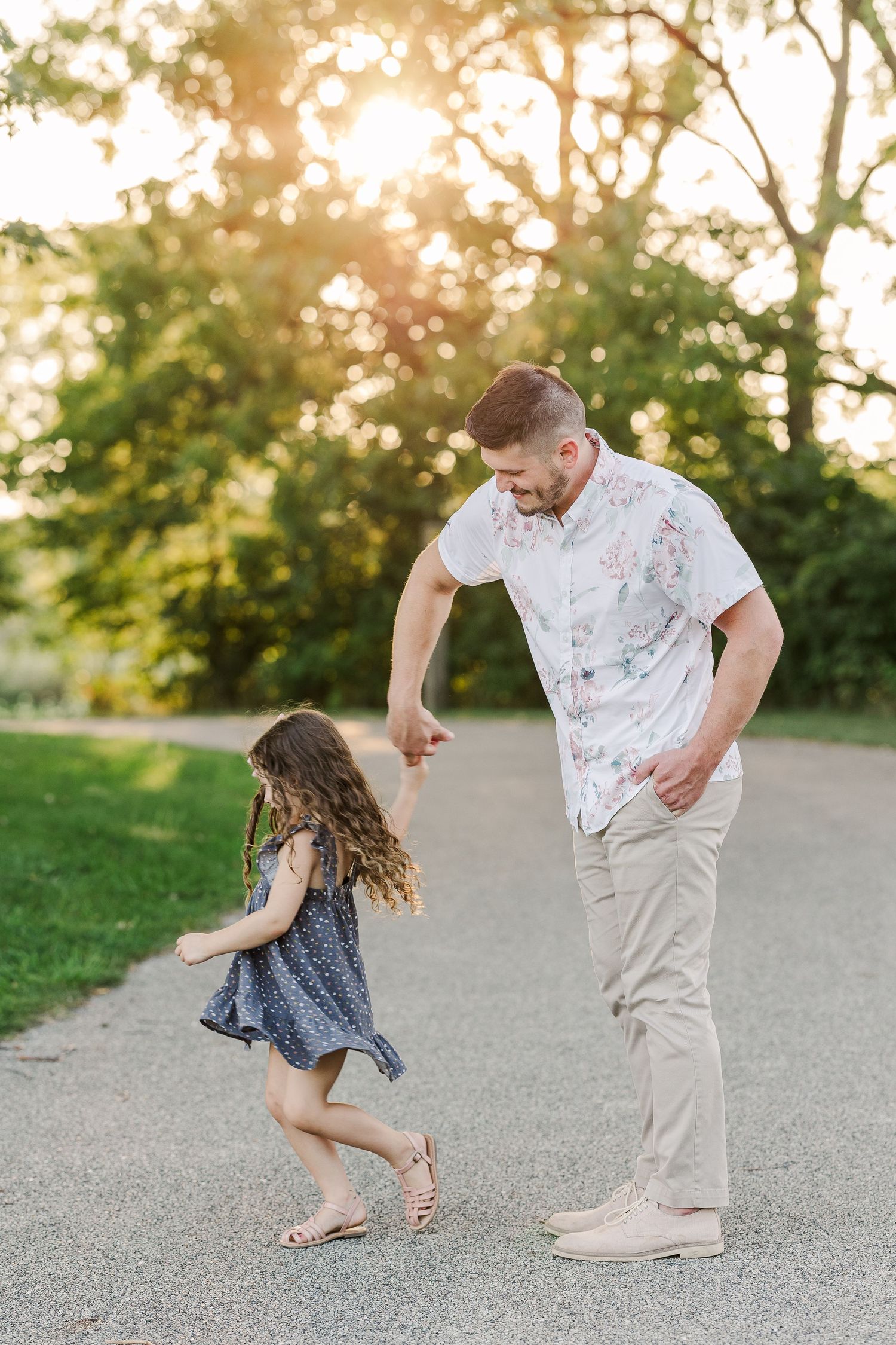 Playful moment showing dancing and movement on park pathway.