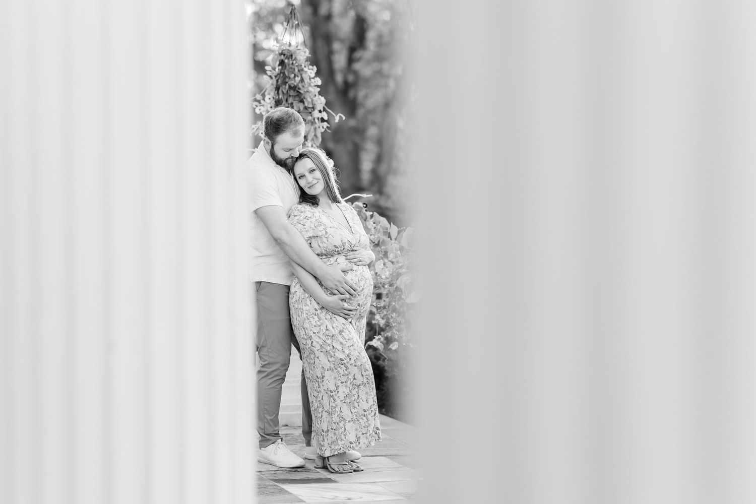 Black and white solo maternity portrait framed by columns during a Cantigny Park maternity session