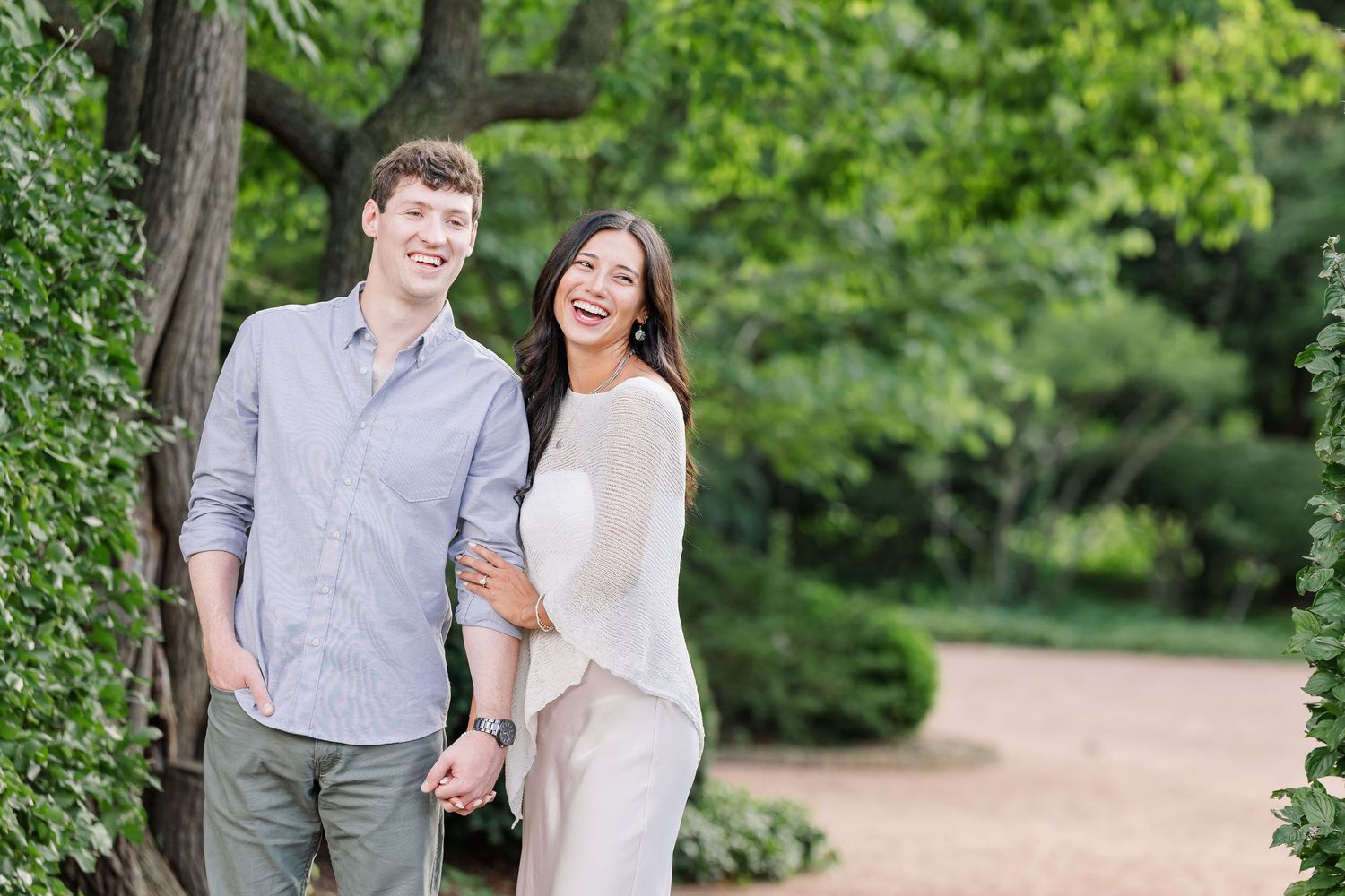 Newly engaged Alysia and Jack walk hand in hand through the gardens at Cantigny Park.