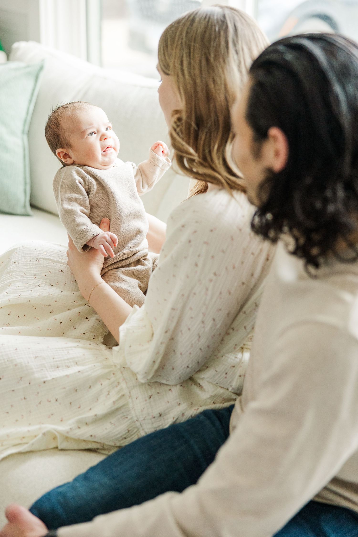 Palatine IL newborn photographer capturing parents interacting with their baby during a bright in-home lifestyle newborn session
