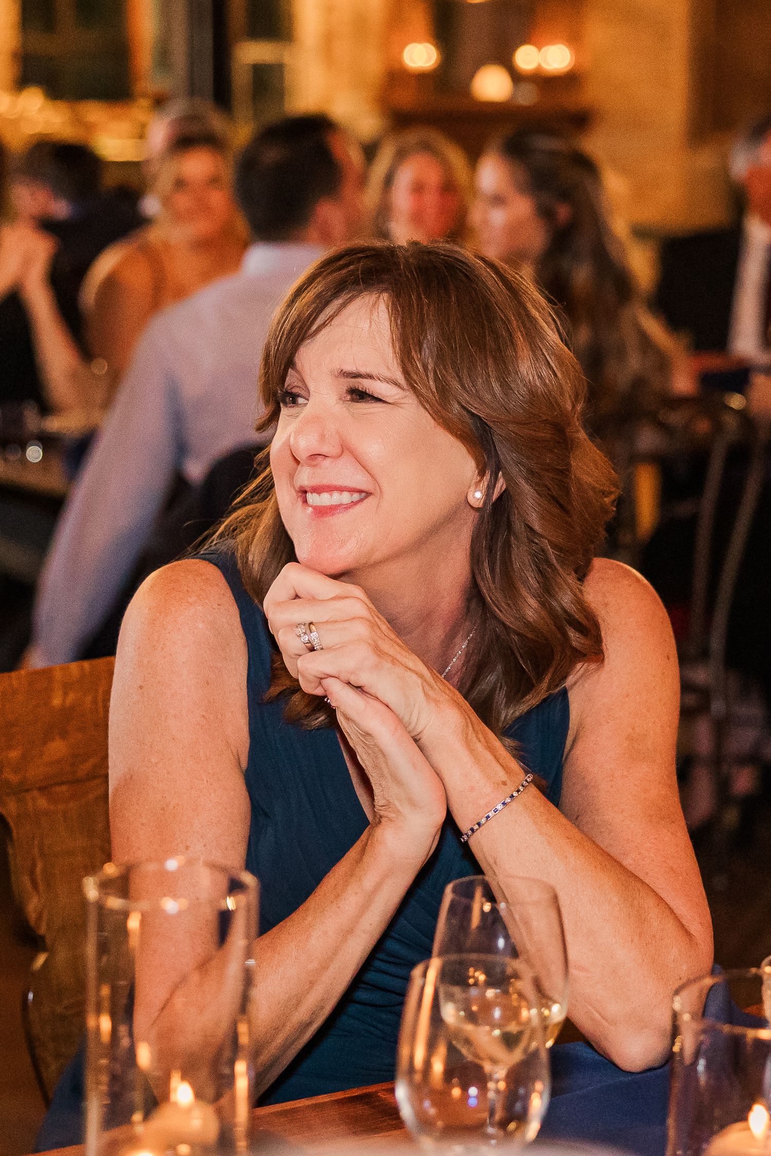 Guest enjoys reception festivities at elegant candlelit venue.