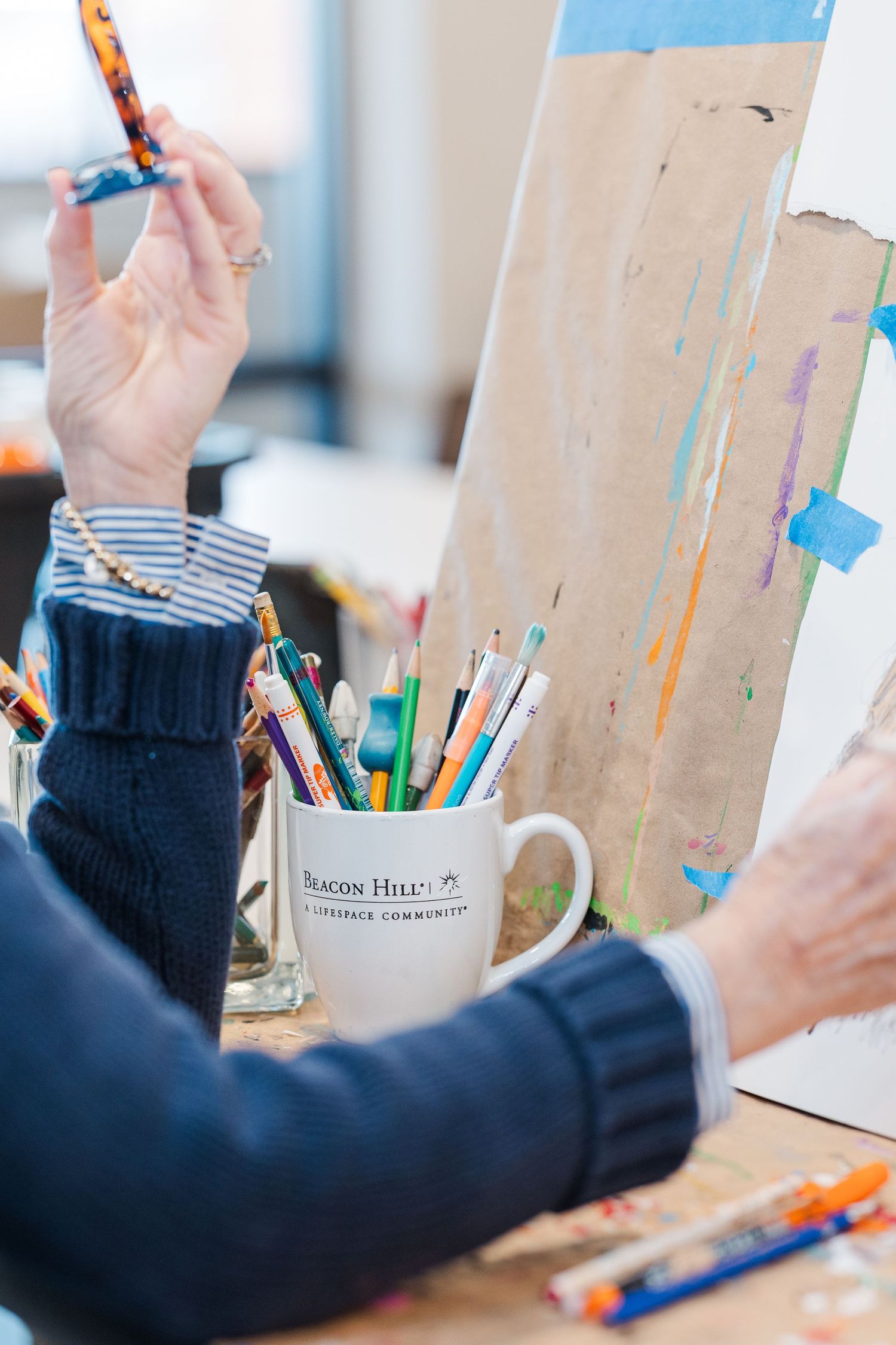 Beacon Hill senior living branding photo in Lombard, Illinois featuring resident painting in art studio