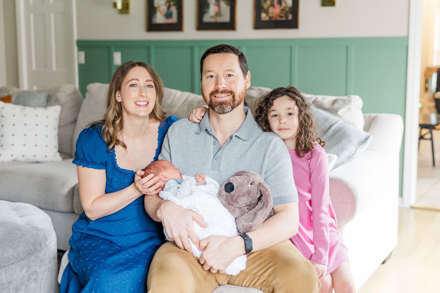 Family of four smiling together during in-home lifestyle newborn session in Crystal Lake, Illinois
