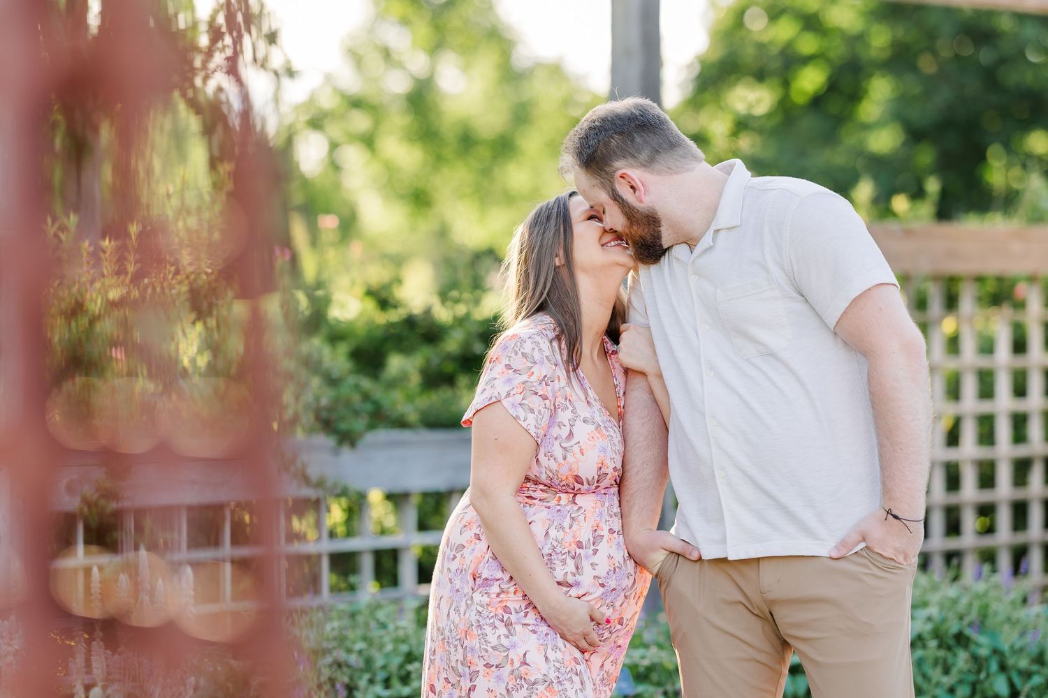 Sweet forehead kiss during a glowy Cantigny Park maternity session in Wheaton Illinois
Expecting couple cuddling in the garden during romant