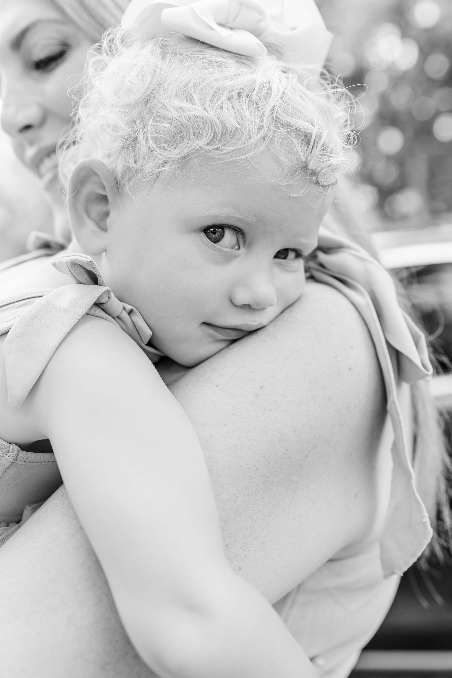 Black and white portrait of a child resting on a parent’s shoulder during a summer family session in Crystal Lake, IL.
