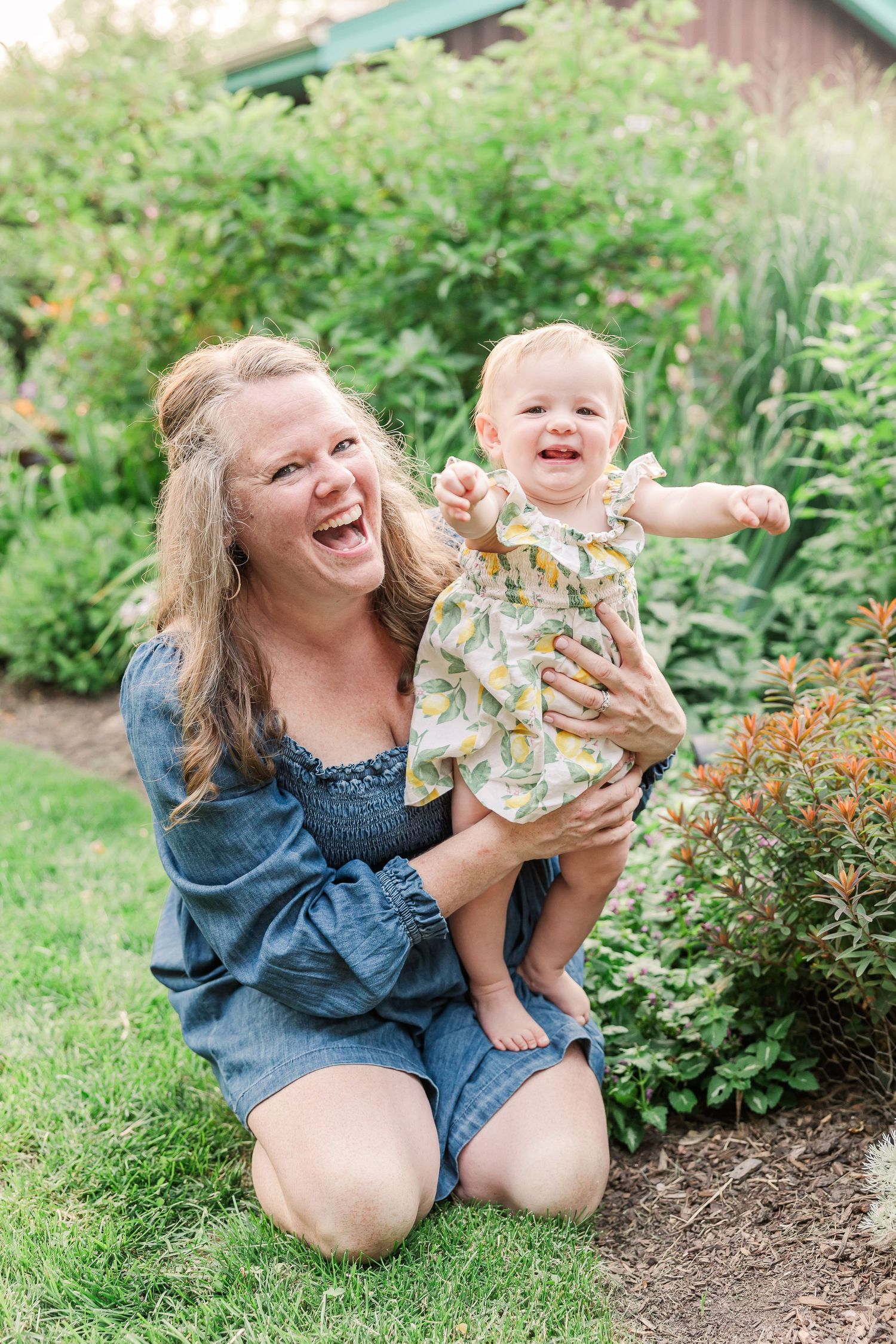 Happy outdoor moment shared on a grassy lawn surrounded by blooming garden flowers.