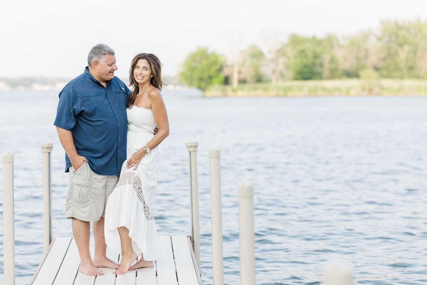 Couple standing on dock during Pistakee Lake family photos in Johnsburg, Illinois