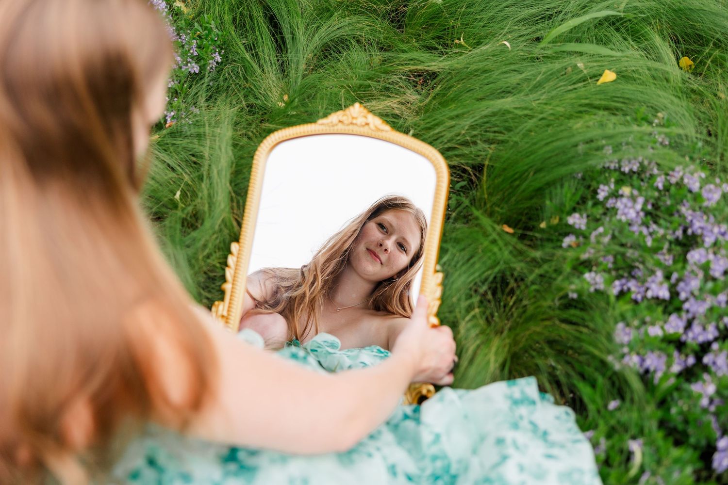 Samantha’s reflection appears in a gold mirror during her whimsical Cantigny Park senior portraits.
