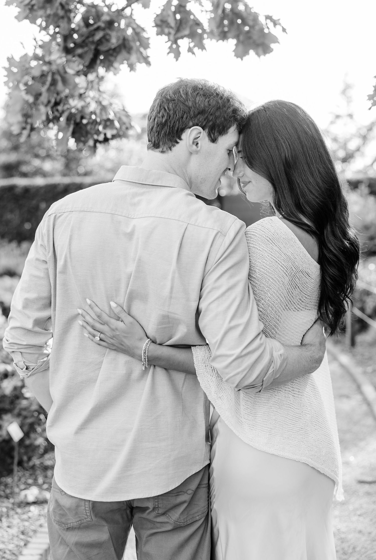 Black-and-white portrait of newly engaged Alysia and Jack sharing a quiet embrace.