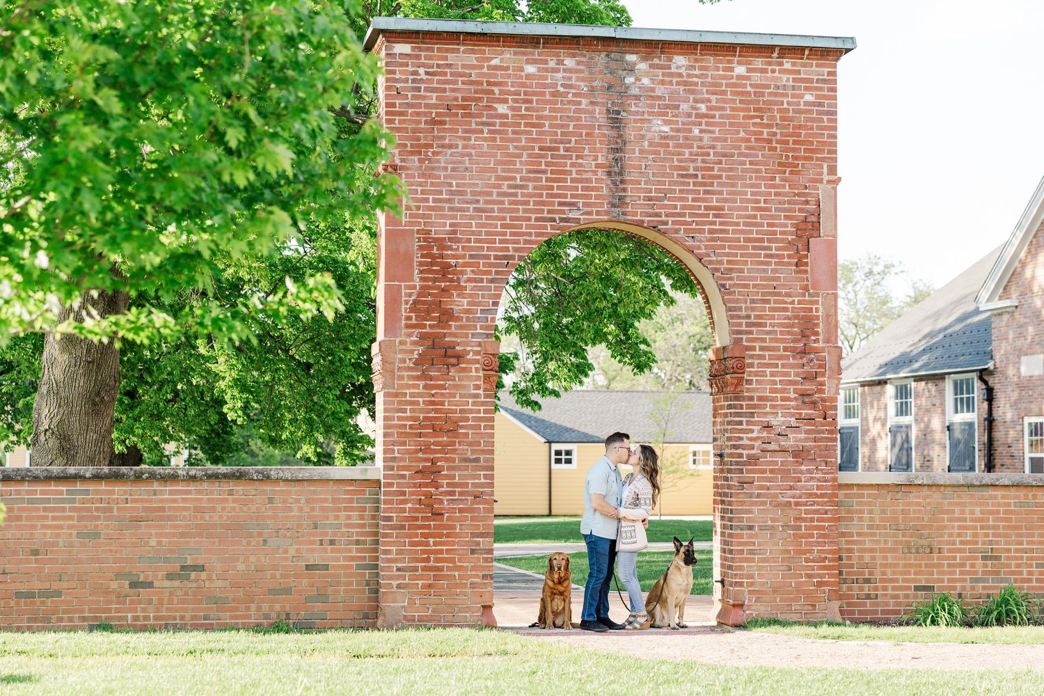 Romantic engagement portrait under the brick arch at St. James Farm Preserve in Warrenville