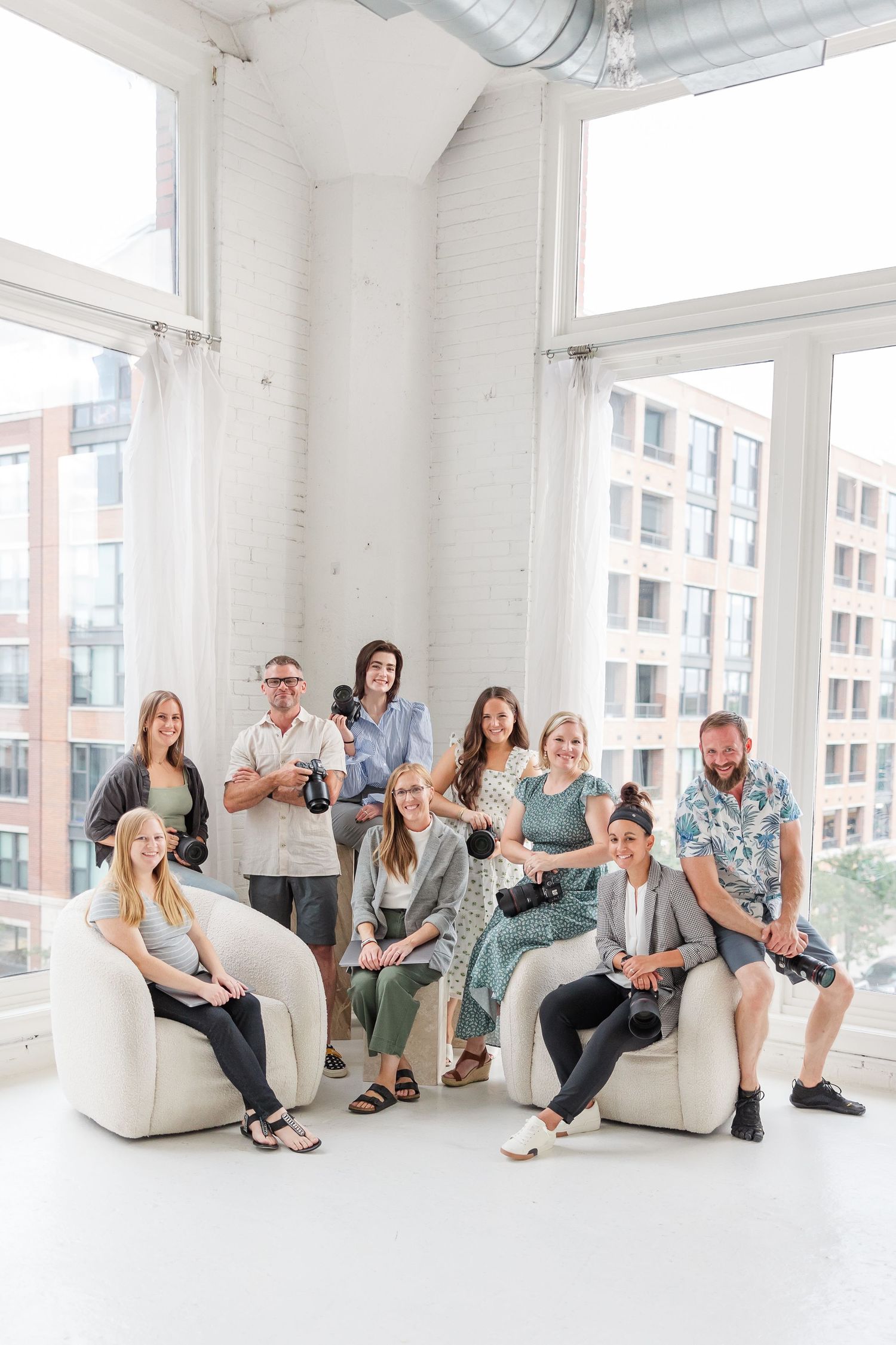 Rachael Watson Photography team posing together in a bright Chicago studio