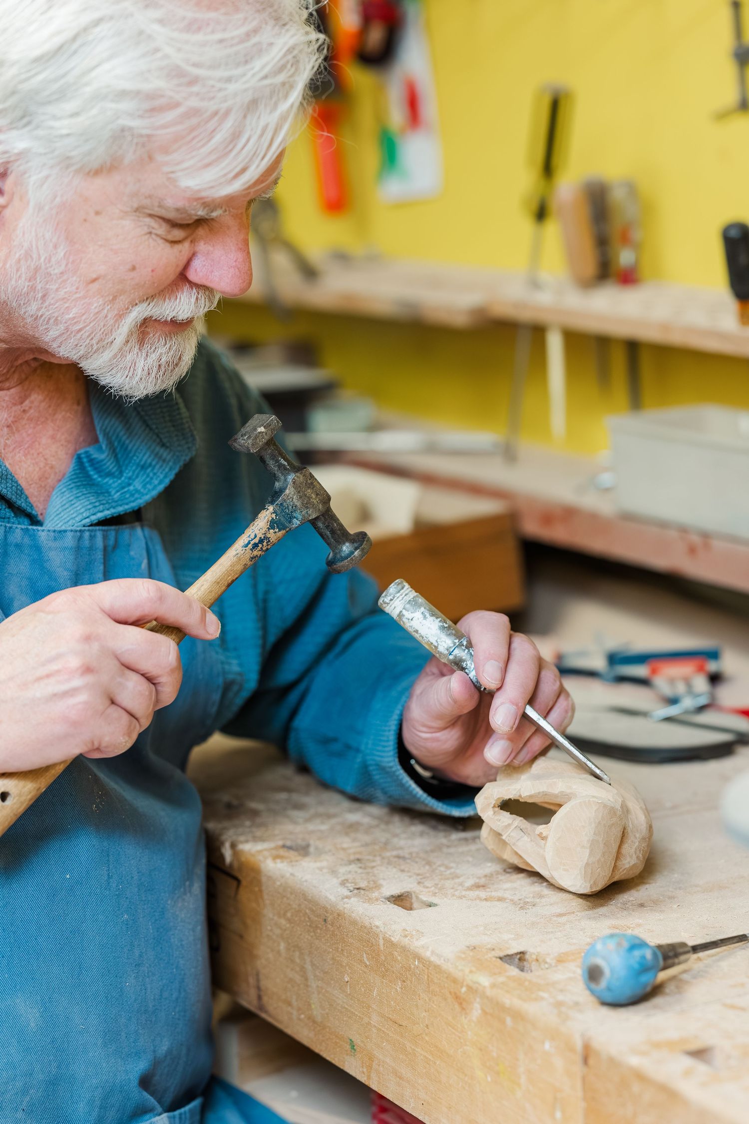 Beacon Hill senior living branding photo in Lombard, Illinois featuring resident using hand tools in workshop