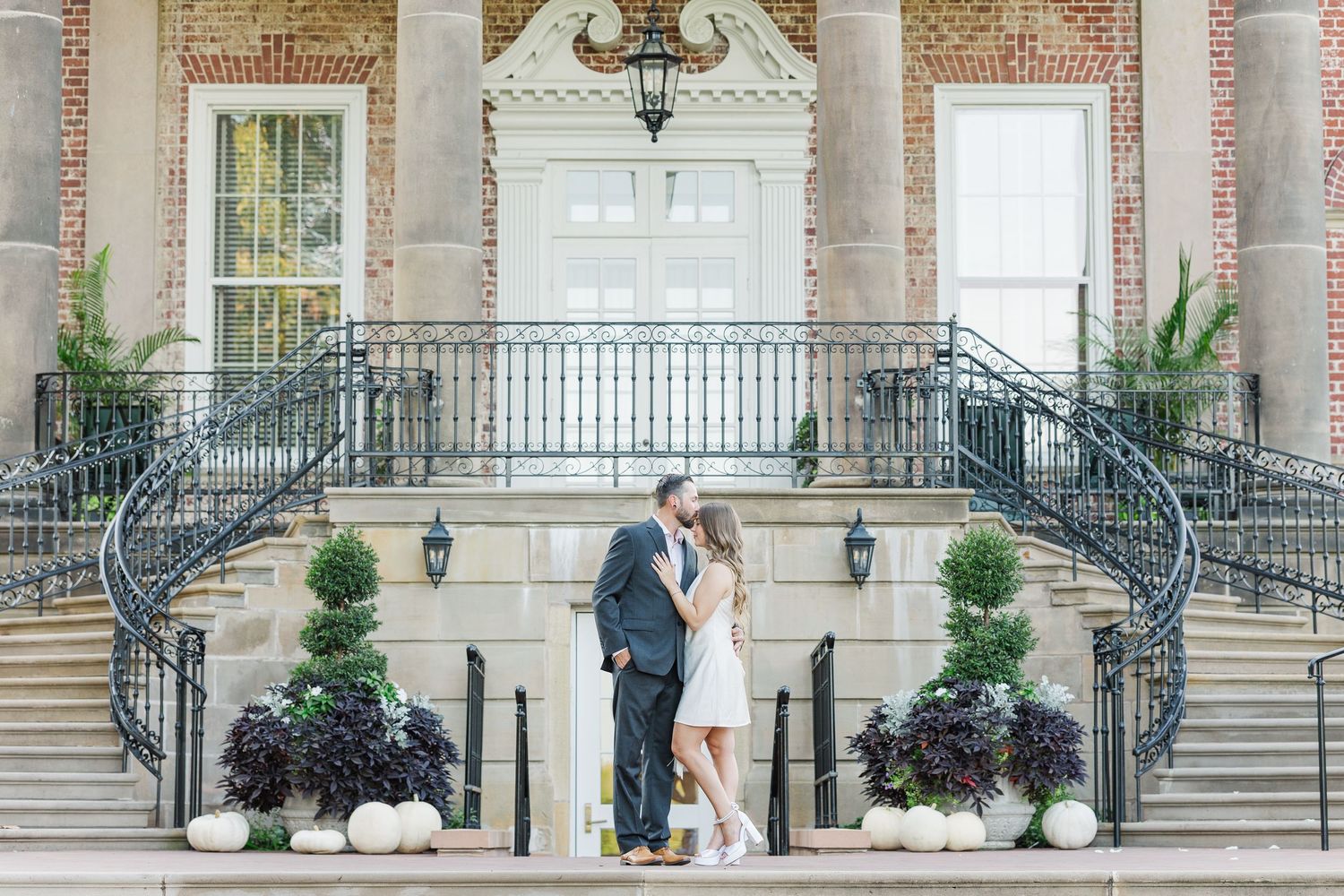 Couple posing on mansion steps during engagement photos at Cantigny Park in Wheaton, Illinois