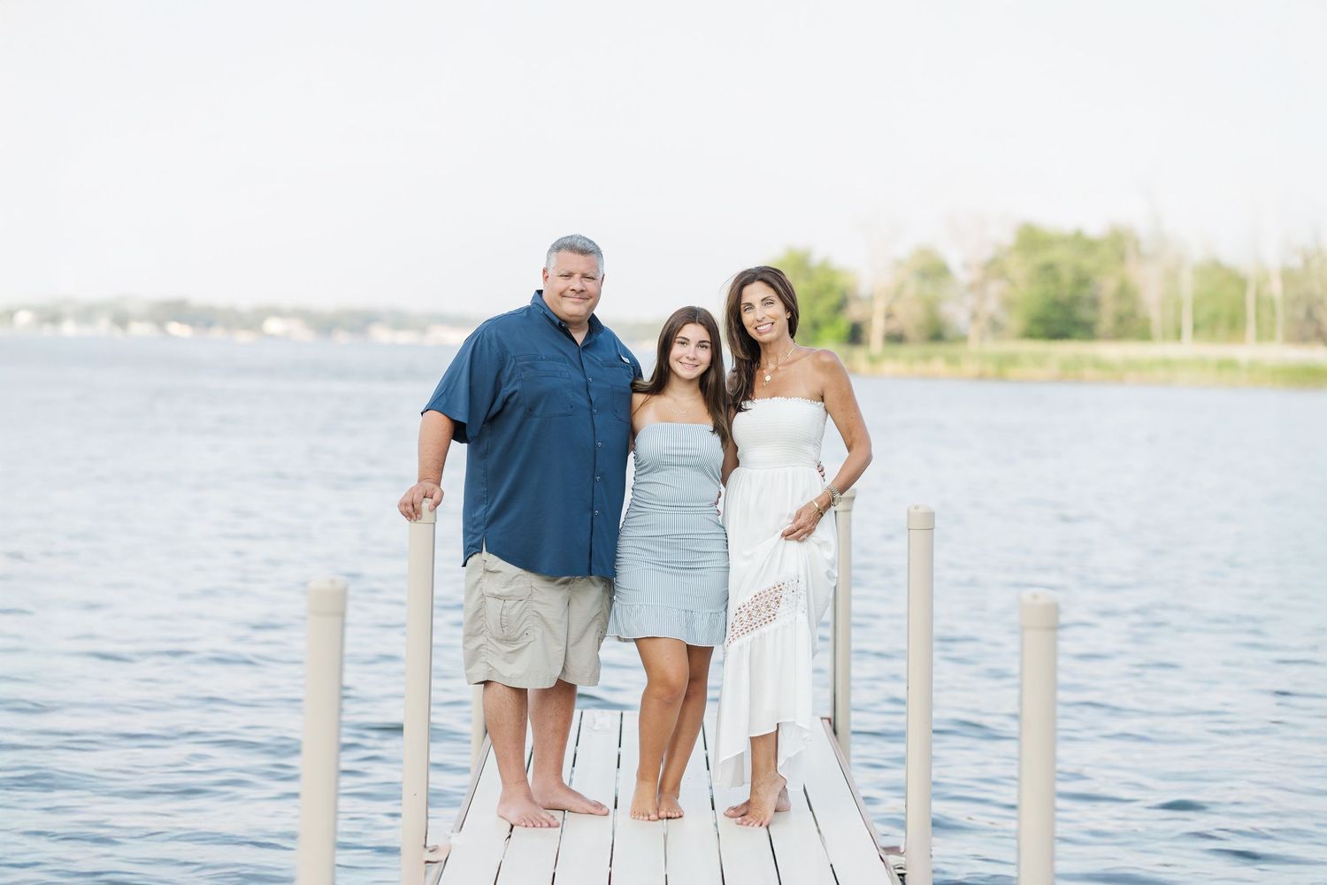 Family posing on dock during Pistakee Lake family photos in Johnsburg, Illinois