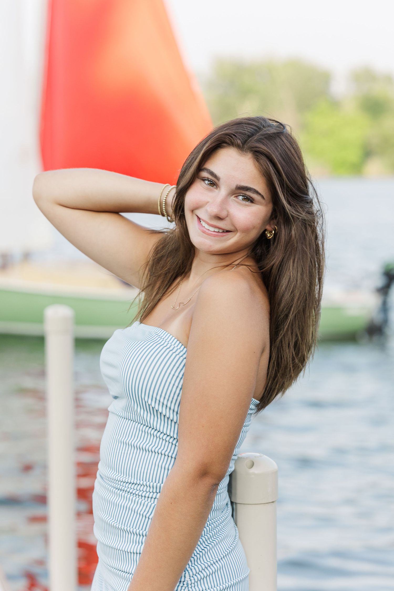 Teen girl portrait by lake during Pistakee Lake family photos in Johnsburg, Illinois