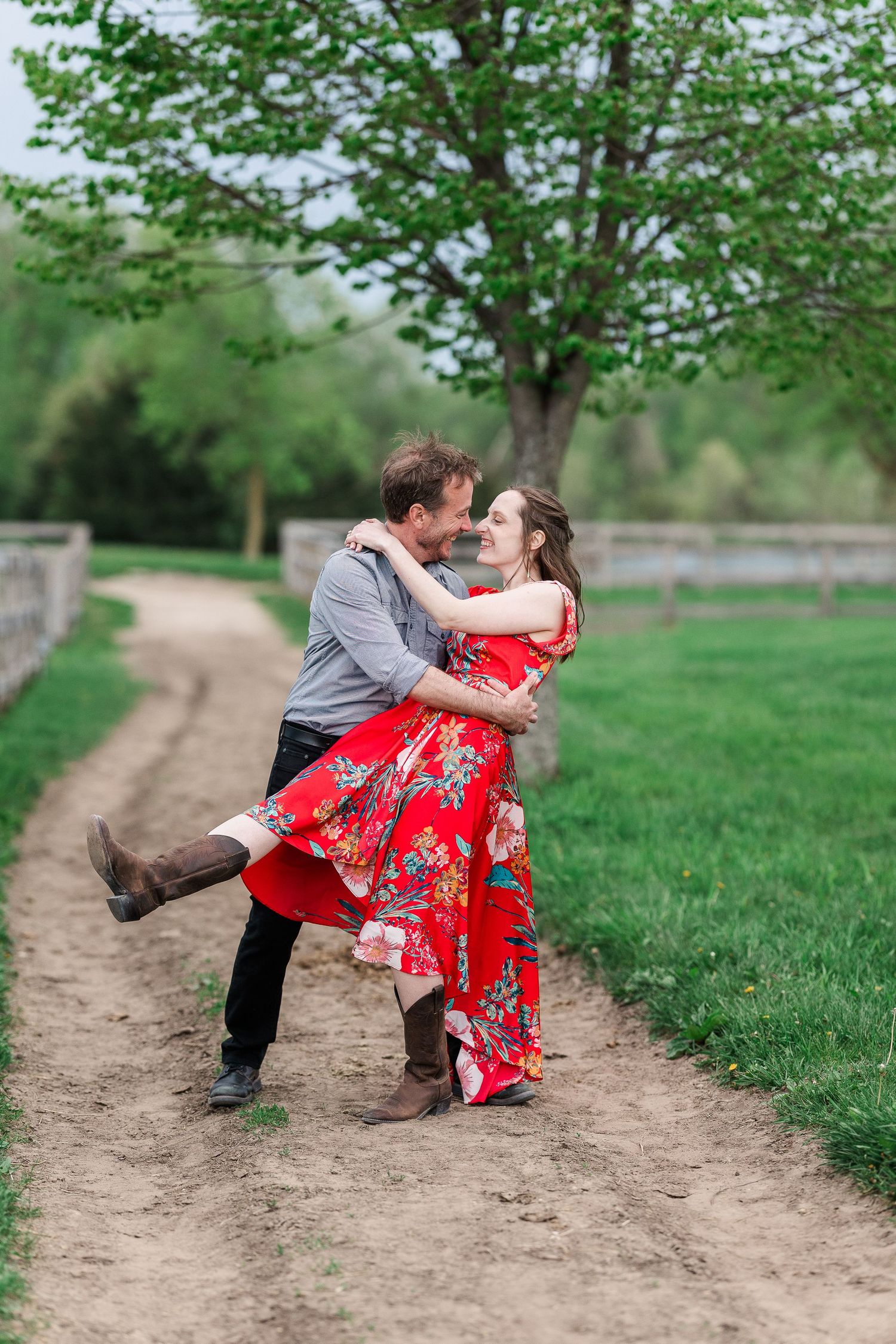 A joyful dance moment captured on a country path surrounded by green spring foliage.