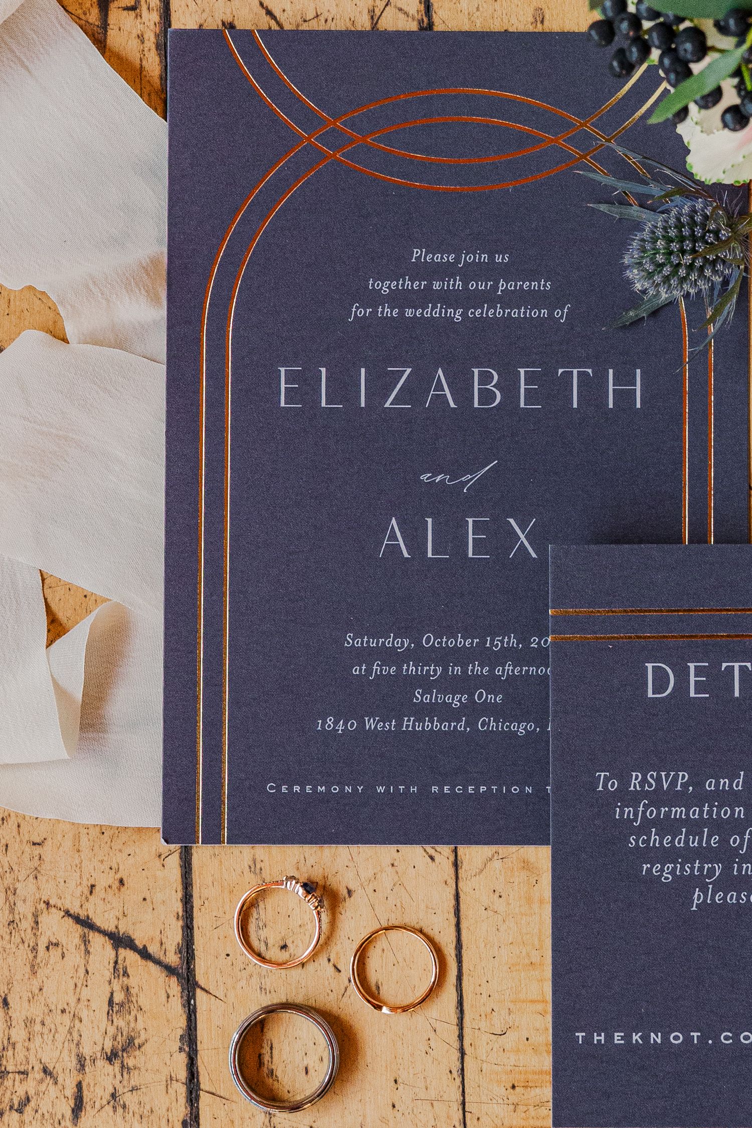 Wedding invitation for Elizabeth and Alex featuring navy blue cards with elegant copper arch designs.