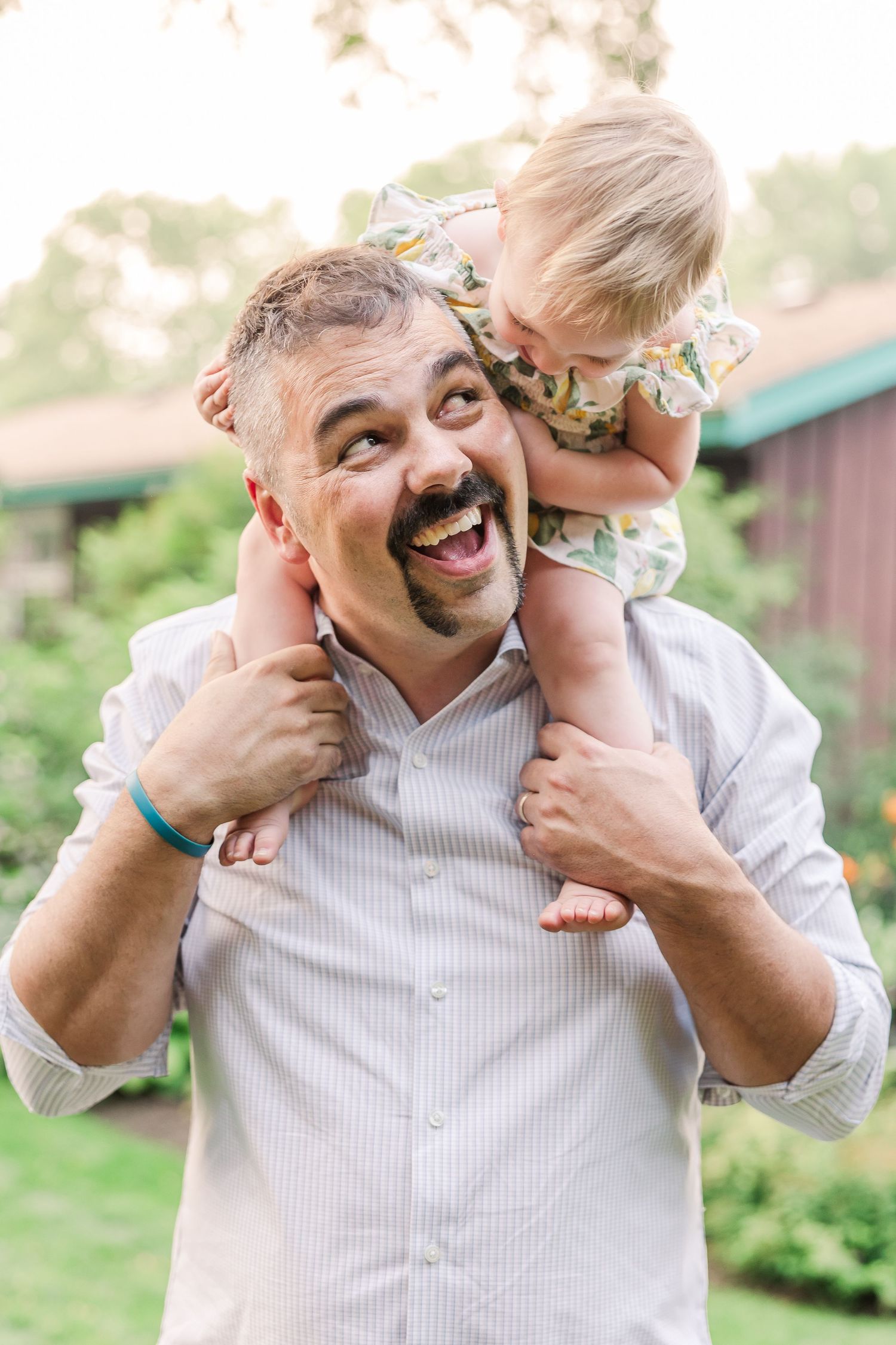 Joyful piggyback ride moment captured in a garden setting.