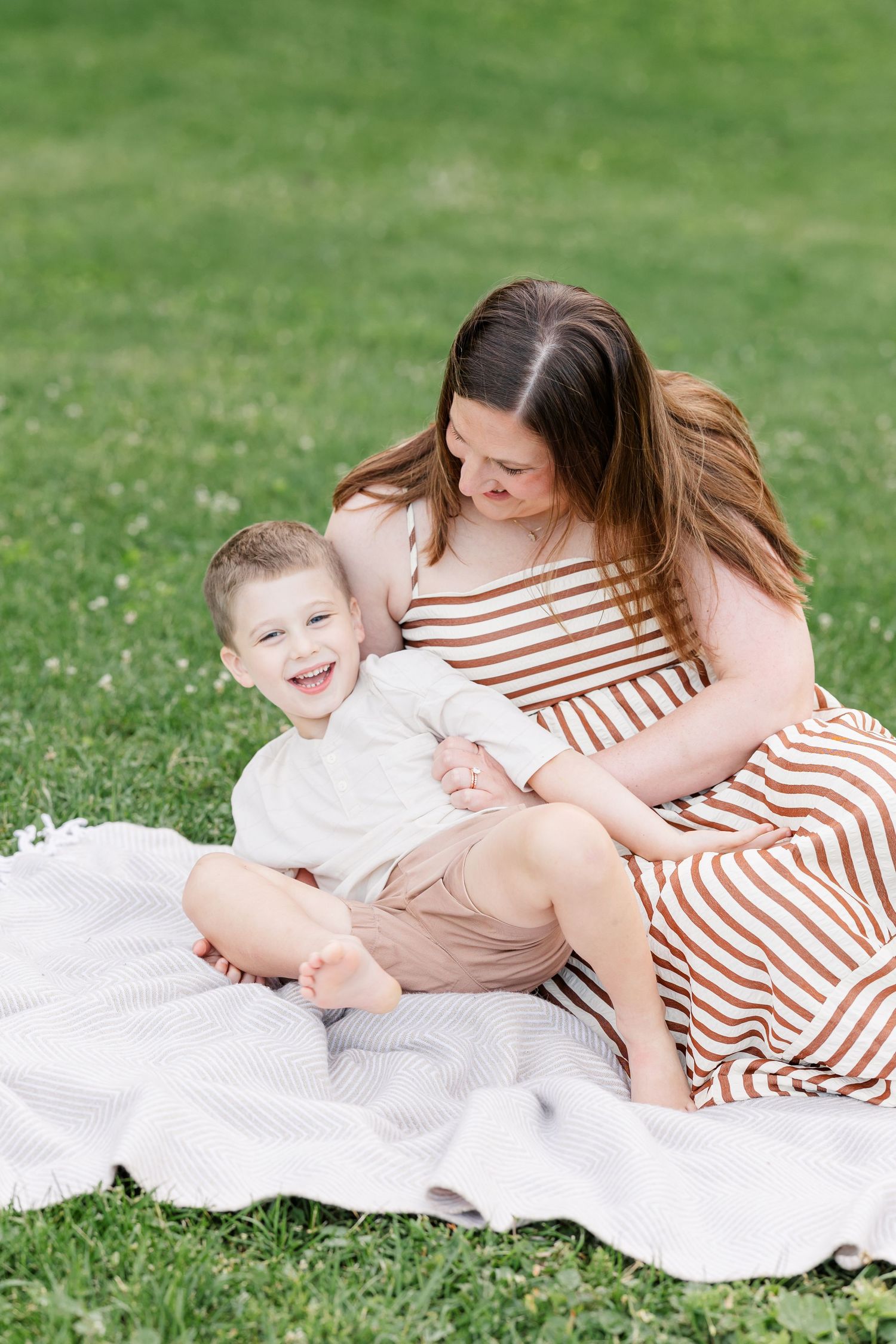 Mom hugging her young son during a relaxed family photography session at Shamrock Hills Park.