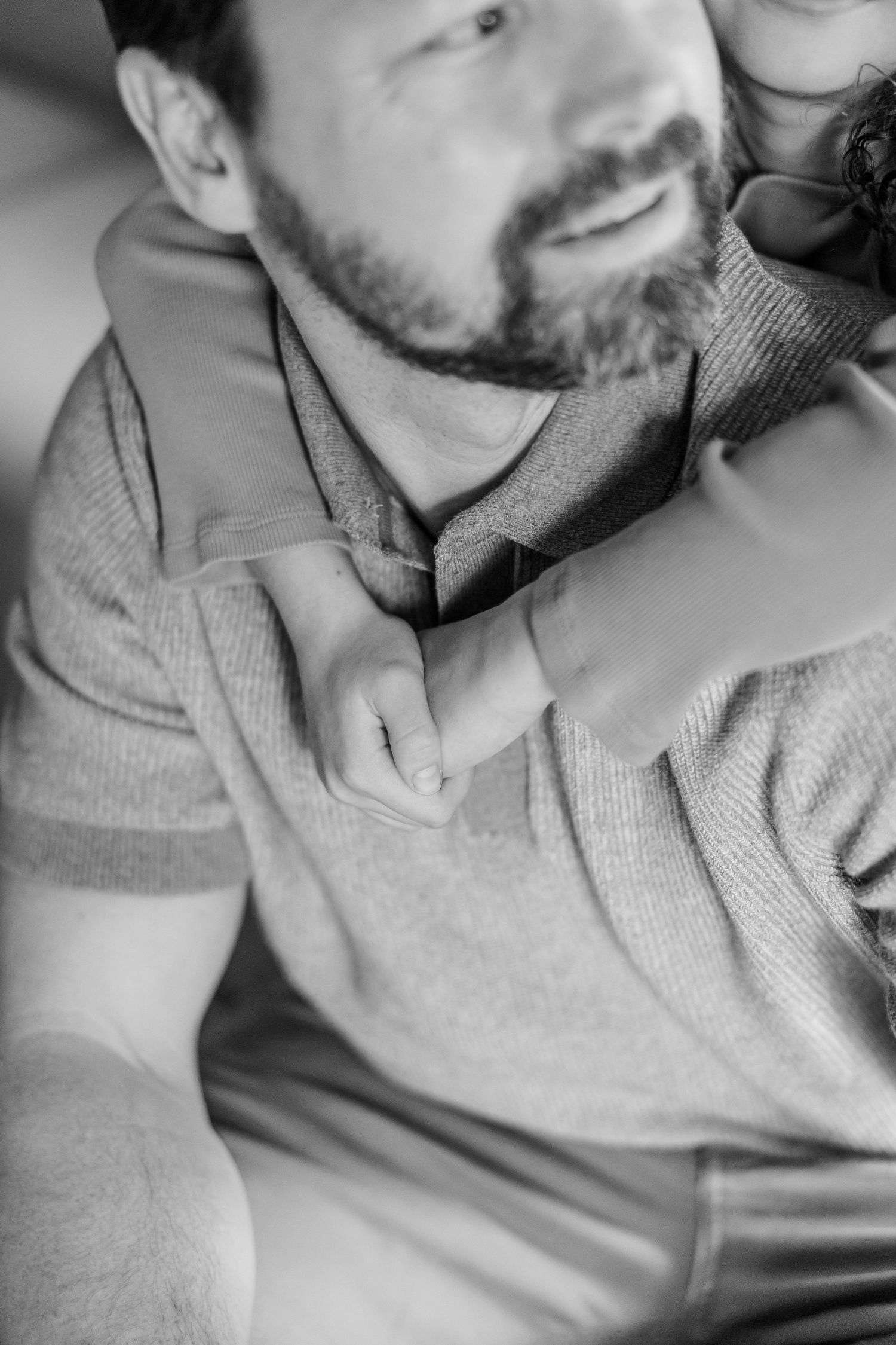 Black and white close-up of father and daughter cuddling during Crystal Lake lifestyle newborn session