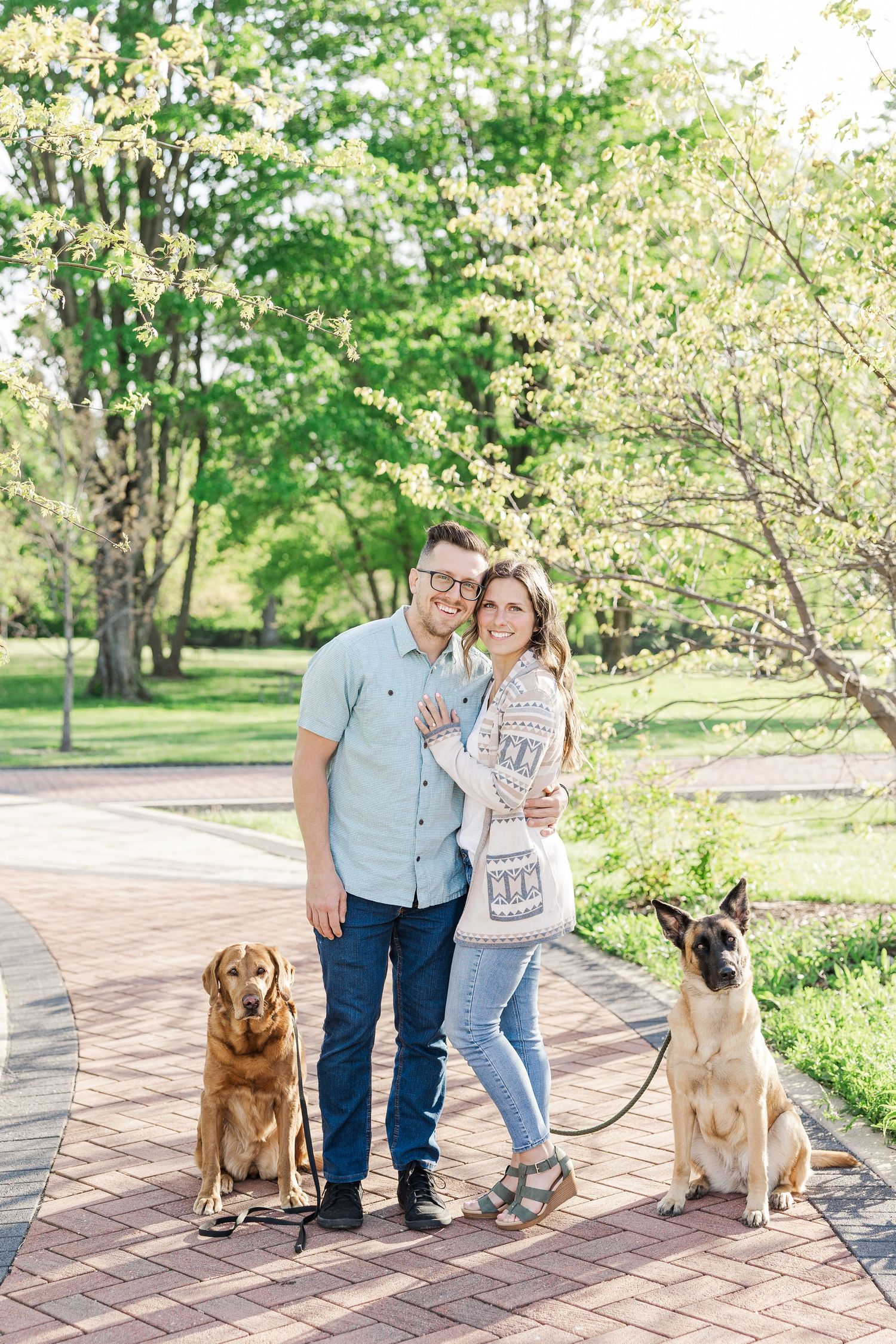 Engaged couple posing with their dogs at St. James Farm Preserve in Warrenville