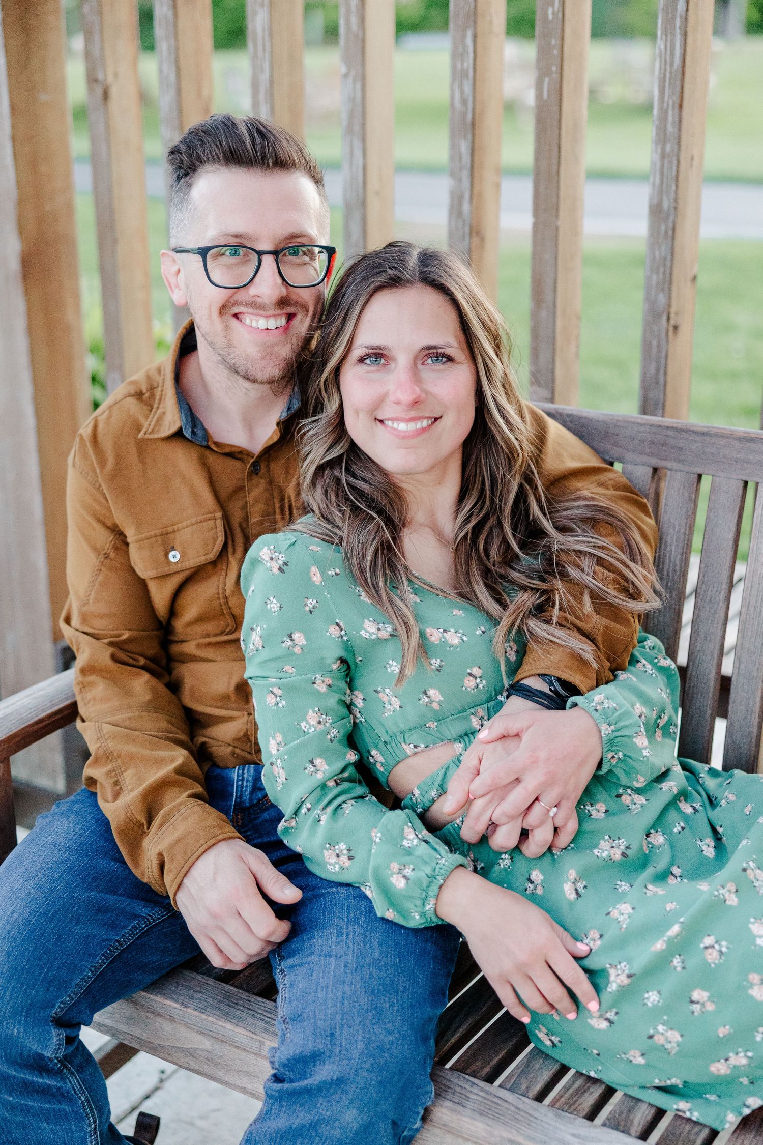 Engaged couple sitting together on a bench during their Cantigny Park engagement session