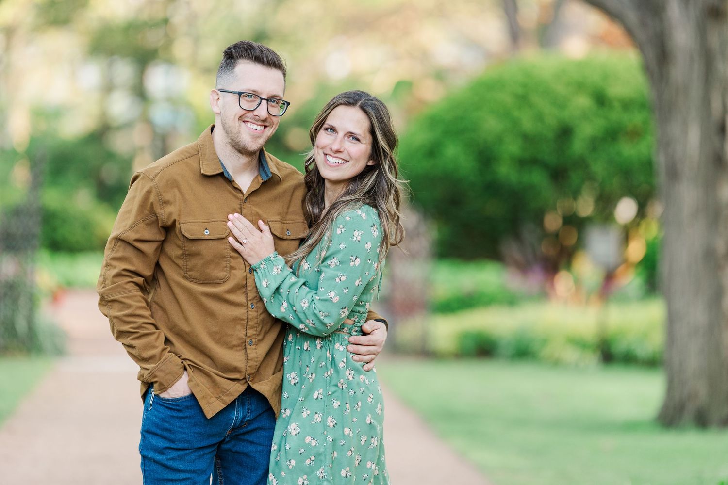 Engaged couple smiling together during their Cantigny Park engagement session in Wheaton Illinois