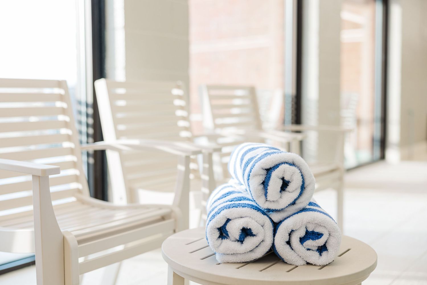 Beacon Hill senior living branding photo in Lombard, Illinois featuring rolled towels by indoor pool