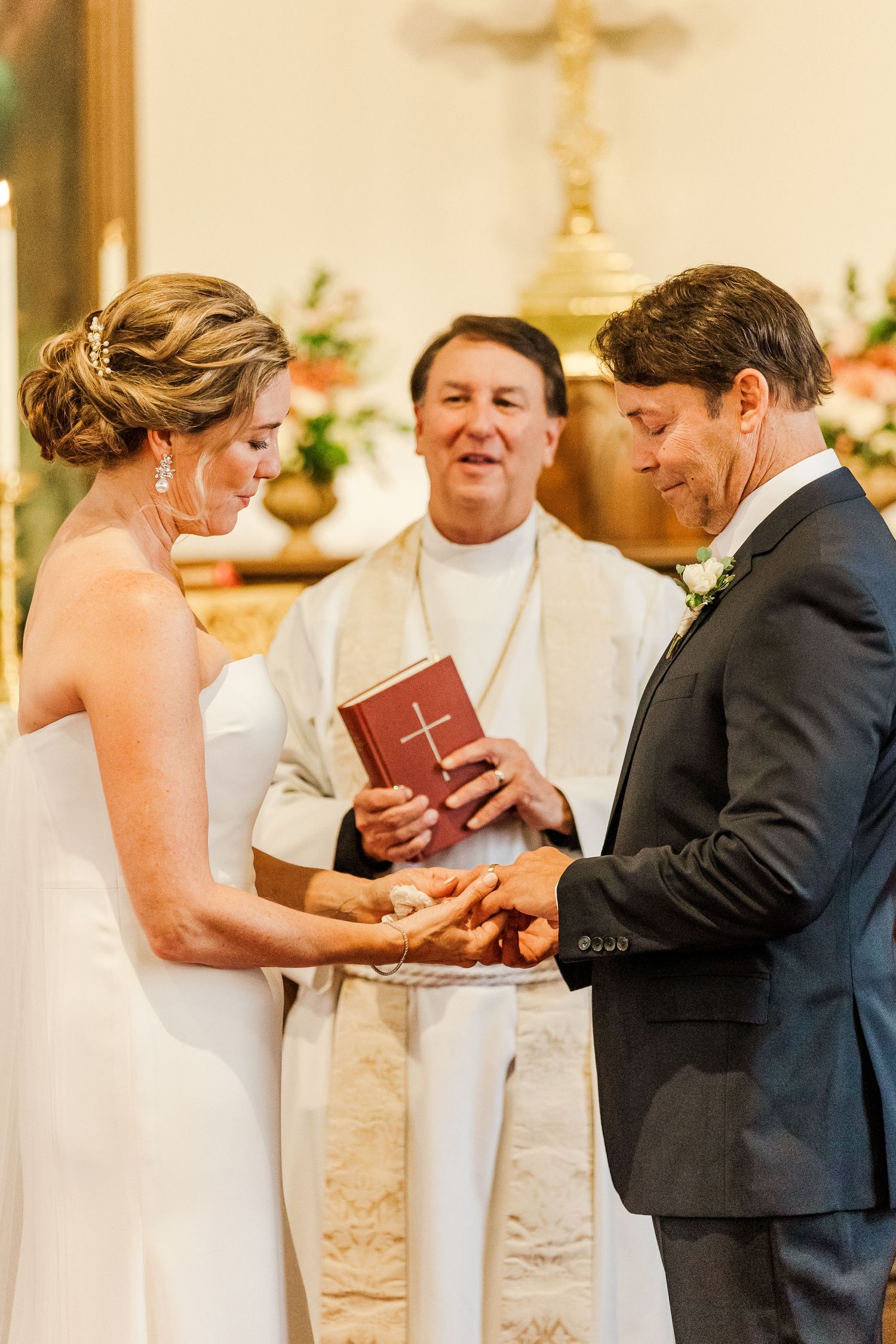 A close-up of a ring exchange ceremony during a traditional church wedding service.