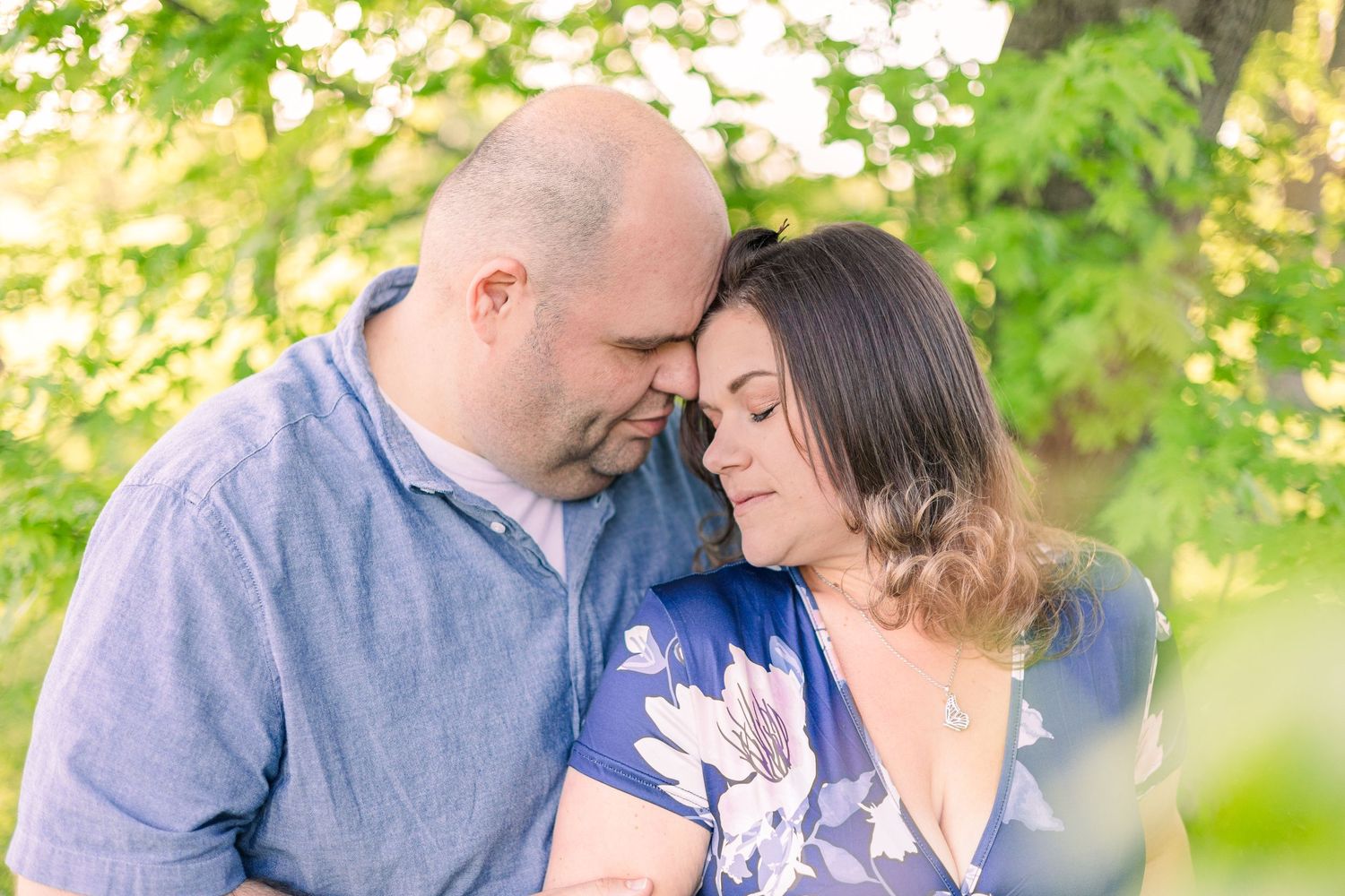 Romantic outdoor portrait with soft lighting and natural green background.