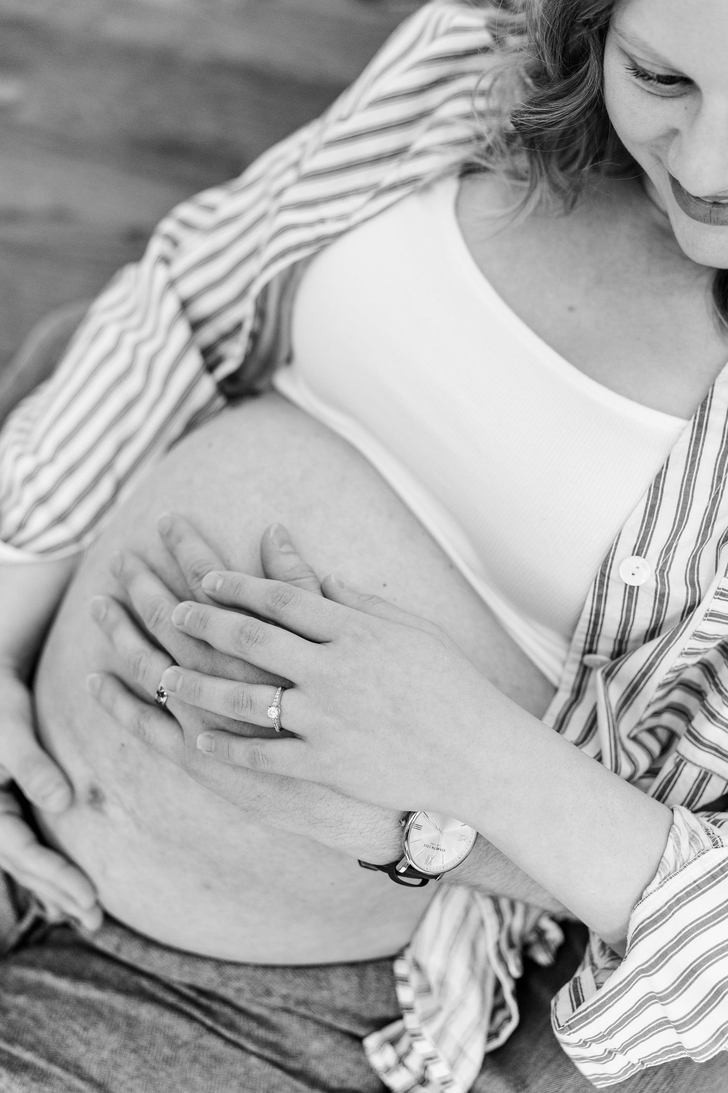 Black and white close-up of mother holding baby bump during a Crystal Lake maternity session.
