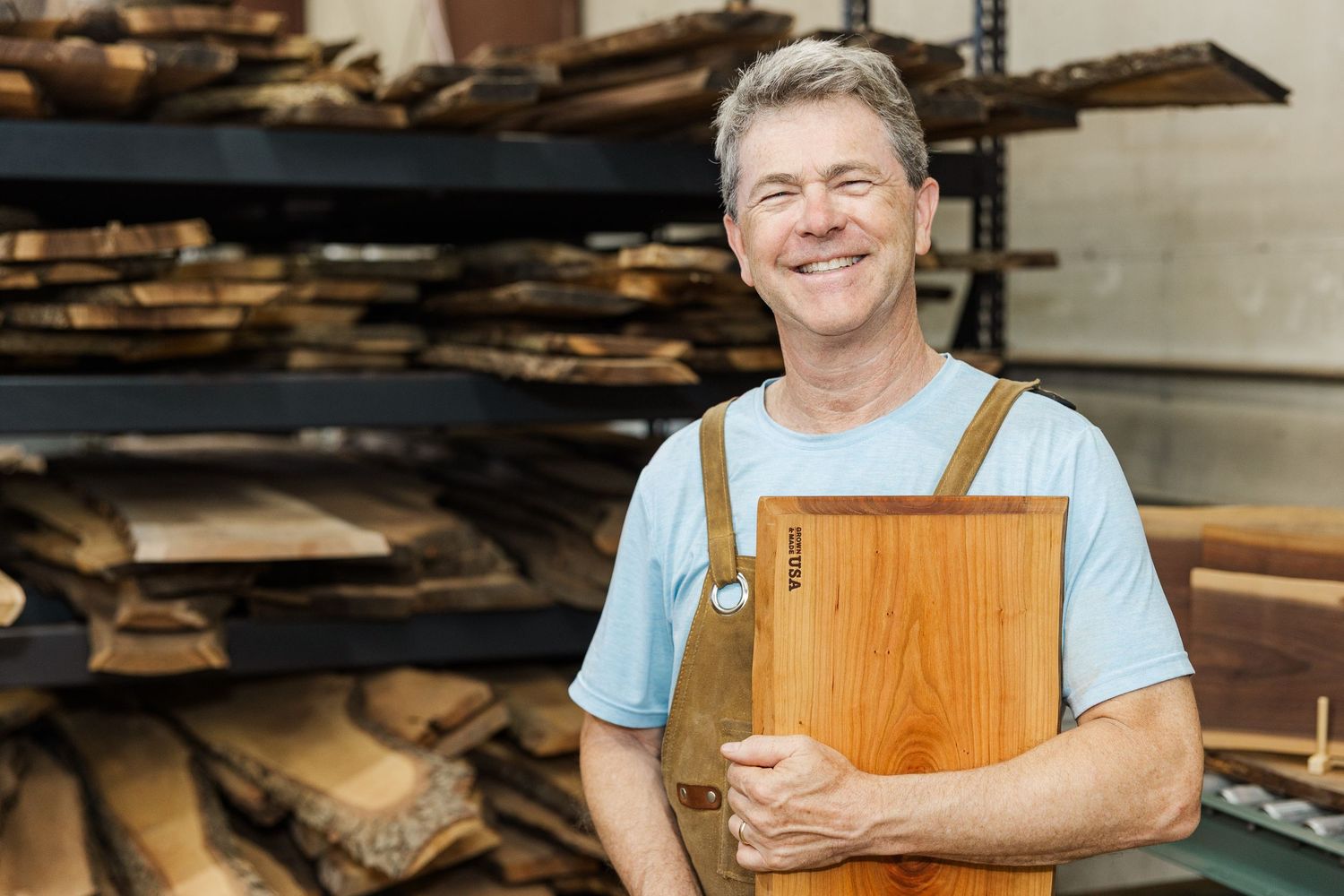 Charcuterie 1 owner branding photo in Huntley, Illinois featuring maker holding handmade board