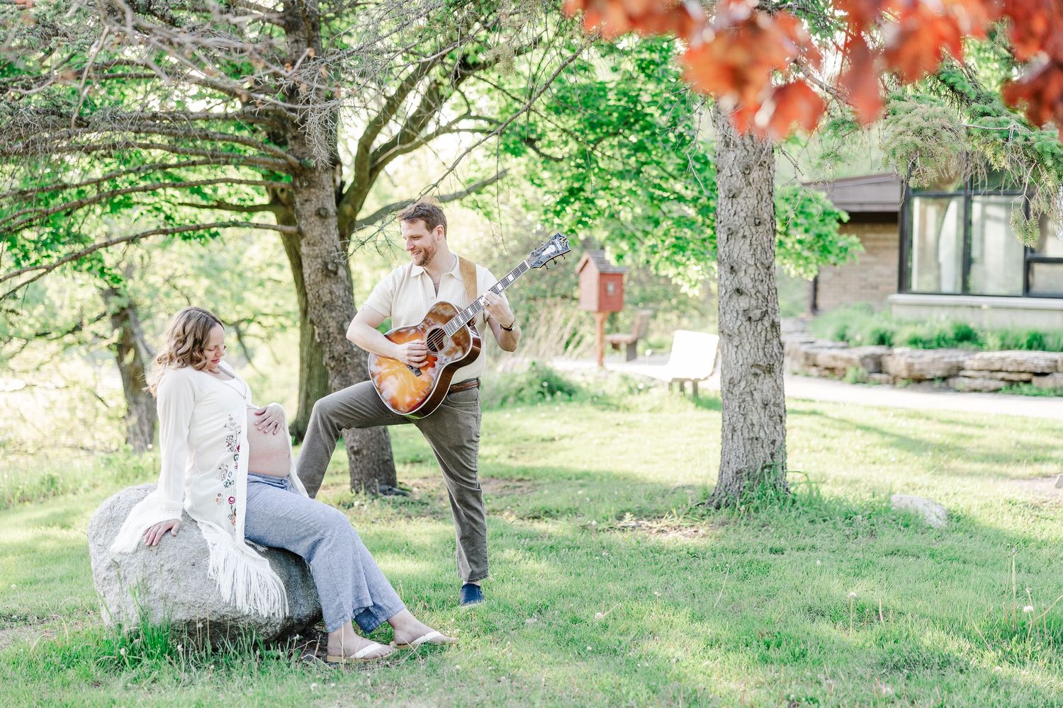 Outdoor maternity session with father playing guitar for mother at the Veterans Acres Nature Center in Crystal Lake, IL.