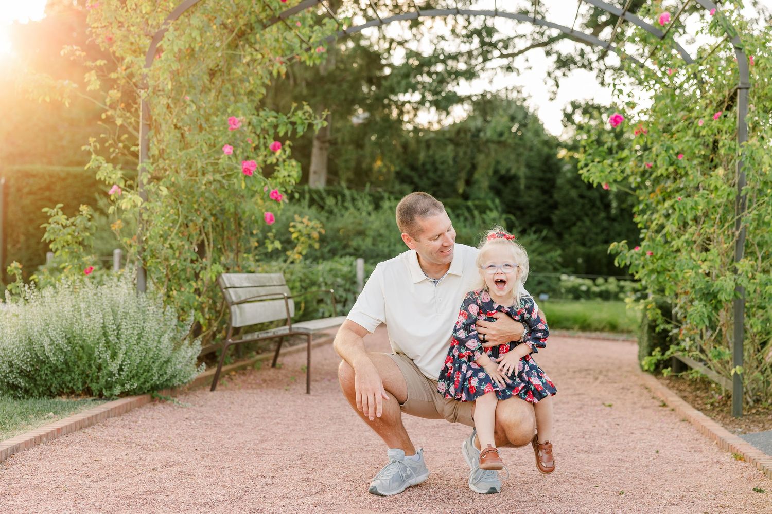 Andrew crouching beside Caroline for a playful father-daughter portrait at Cantigny Park.