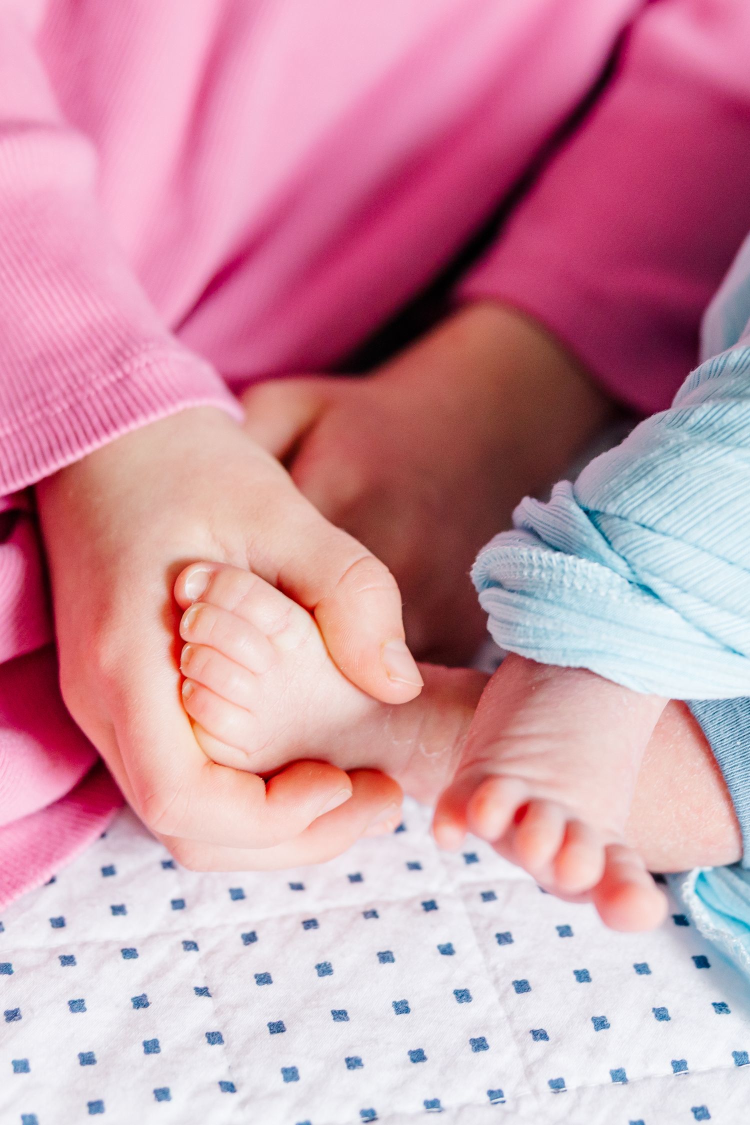 Big sister holding newborn hand during in-home lifestyle newborn session in Crystal Lake, Illinois