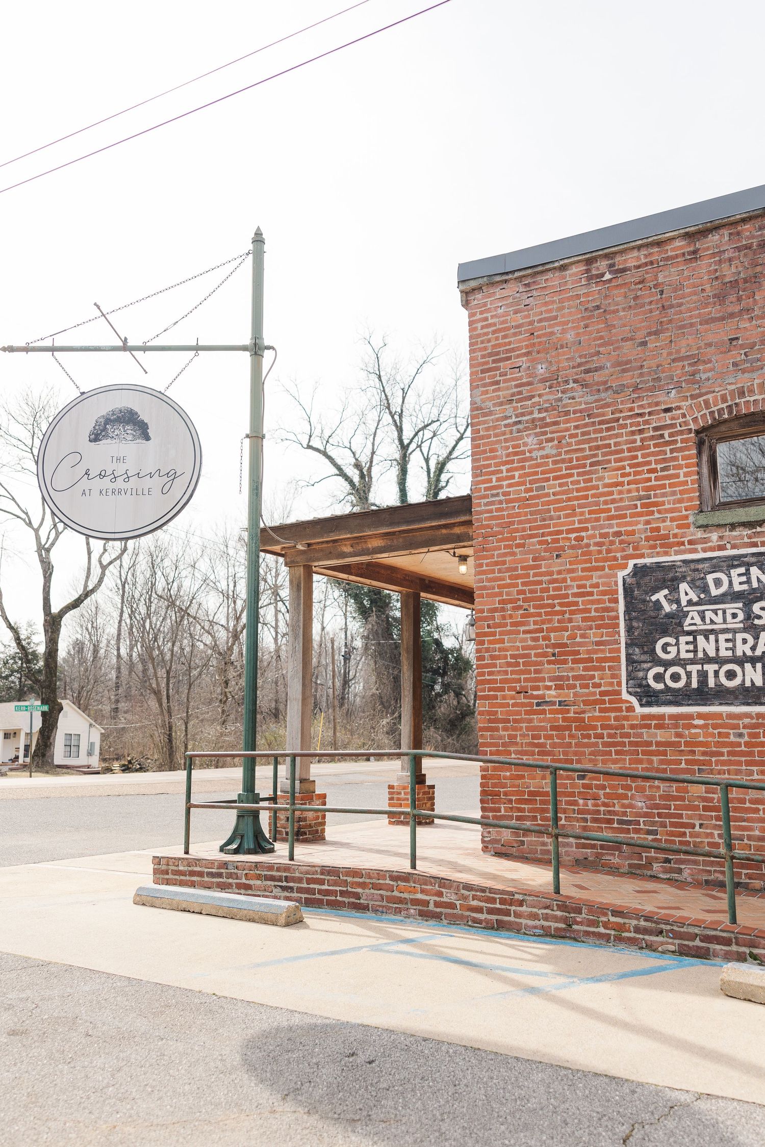 Exterior view of The Crossing restaurant with vintage brick walls and mounted signage.