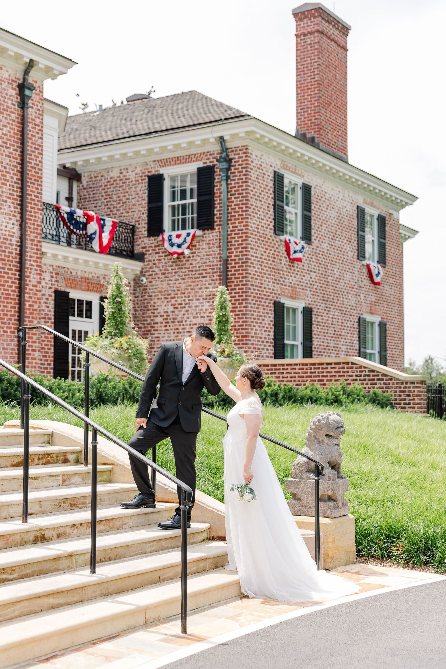 Bride and groom walking down the steps outside McCormick House during their Cantigny Park wedding portraits.