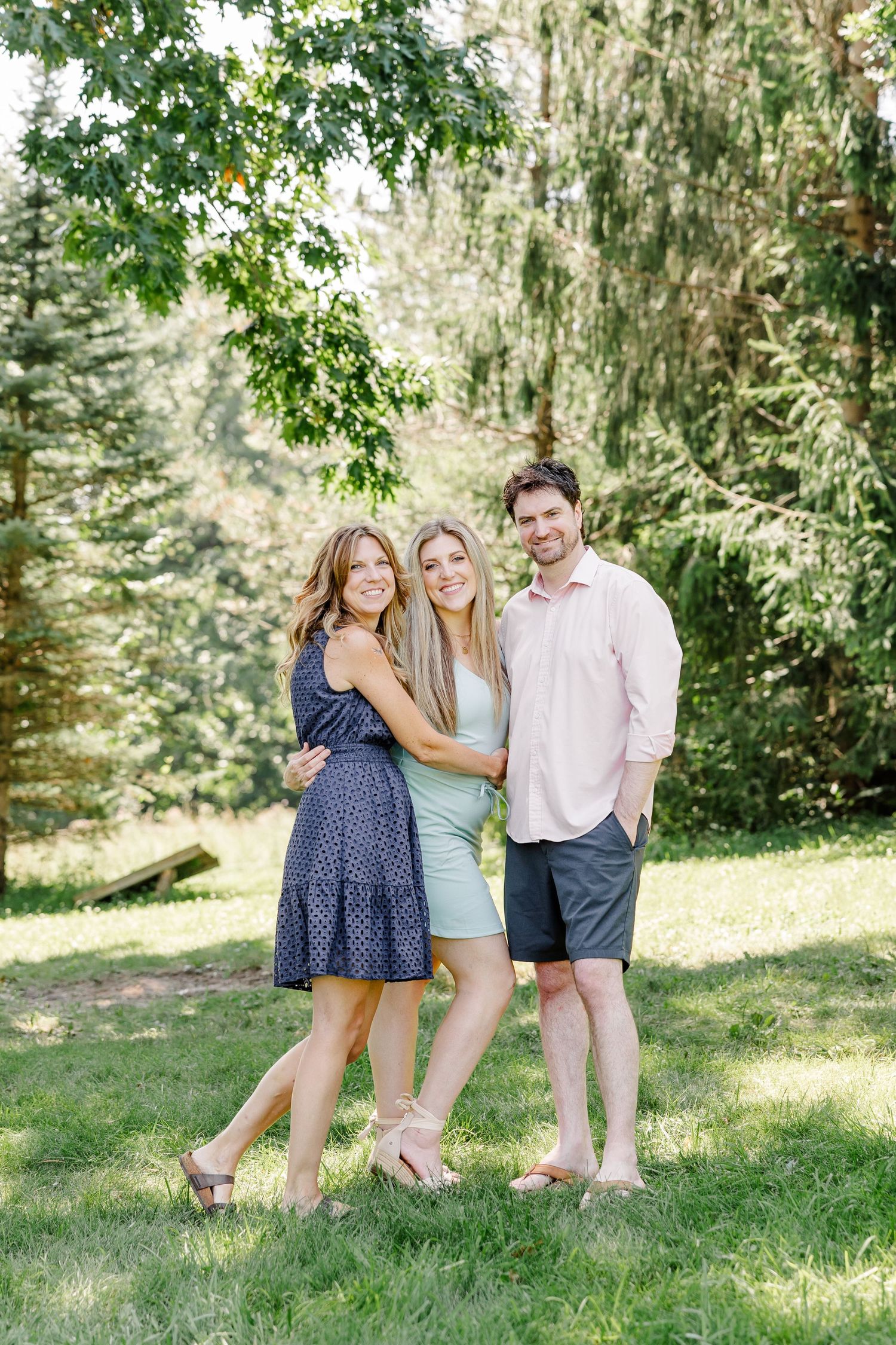 Couple standing together outdoors during a bright summer extended family session in Crystal Lake, Illinois.