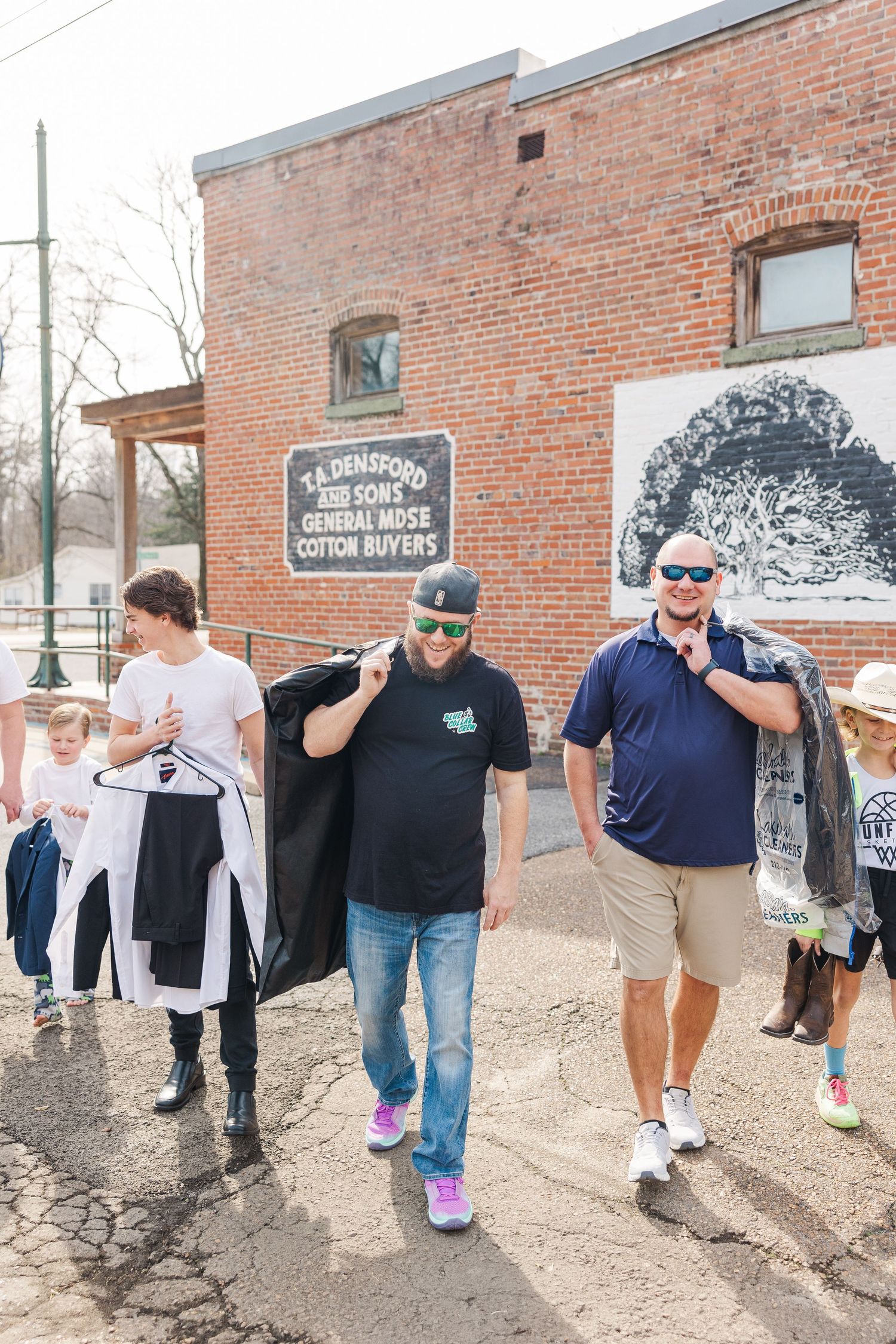 Group walking outside a brick building with The Crossing signage visible.