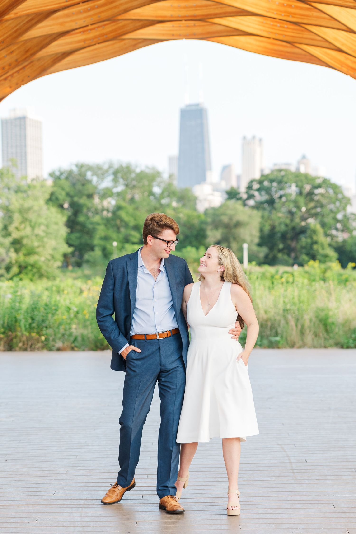 Elizabeth and Joe standing under the Honeycomb Pavilion in Lincoln Park, Chicago, smiling at each other