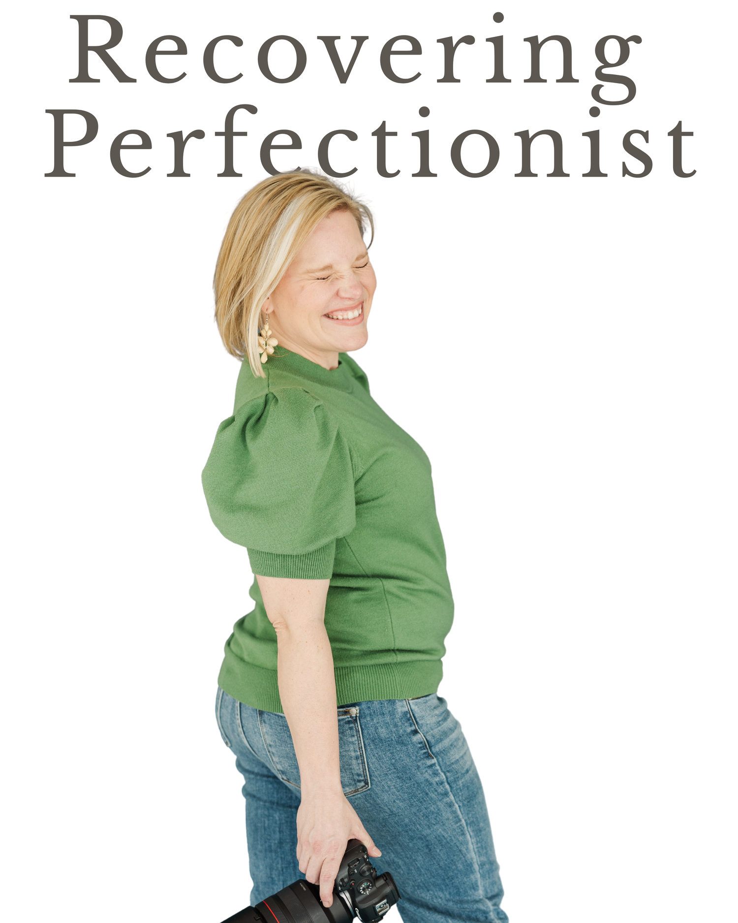 Cassie Lacina smiling in a green sweater while holding her camera in studio branding portraits