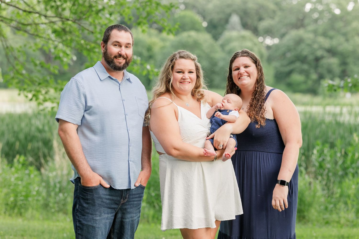 Family members smiling with baby boy during an extended family portrait session in Crystal Lake, Illinois