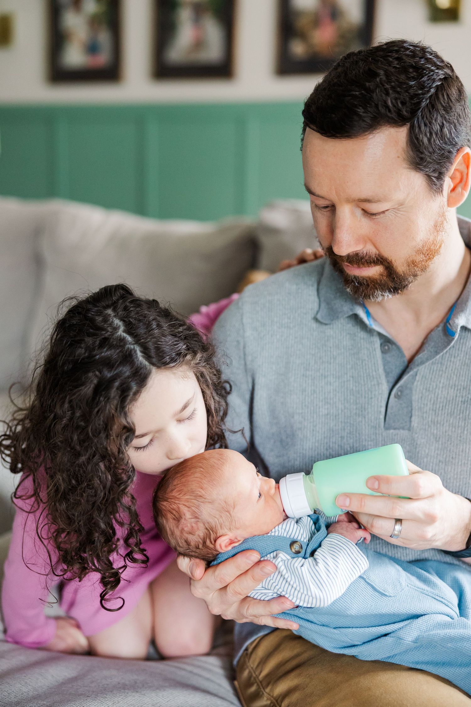 Father and daughter admire newborn baby during in-home lifestyle newborn session in Crystal Lake, Illinois