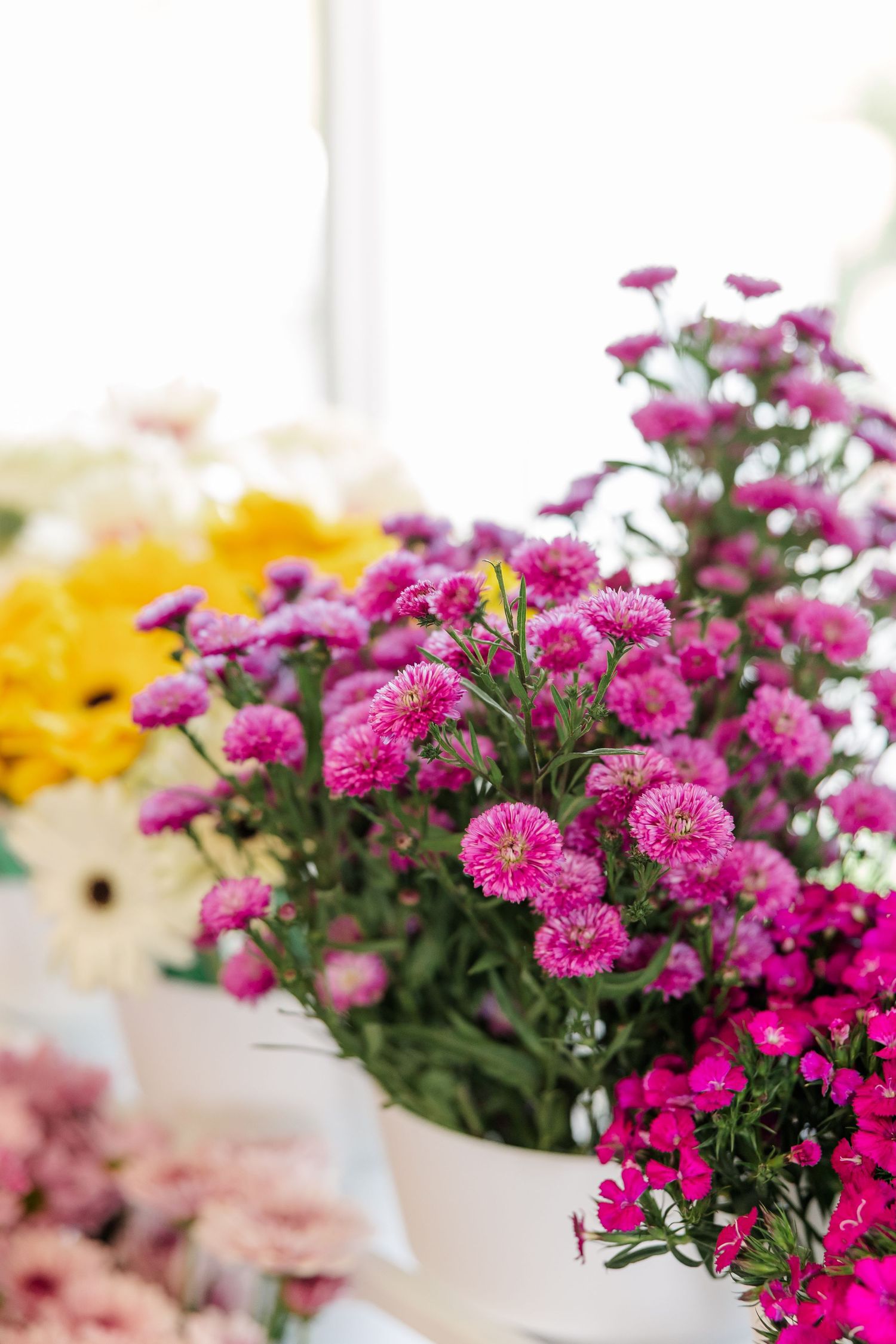 Pink and yellow wildflower arrangement at Itasca Country Club bridal shower